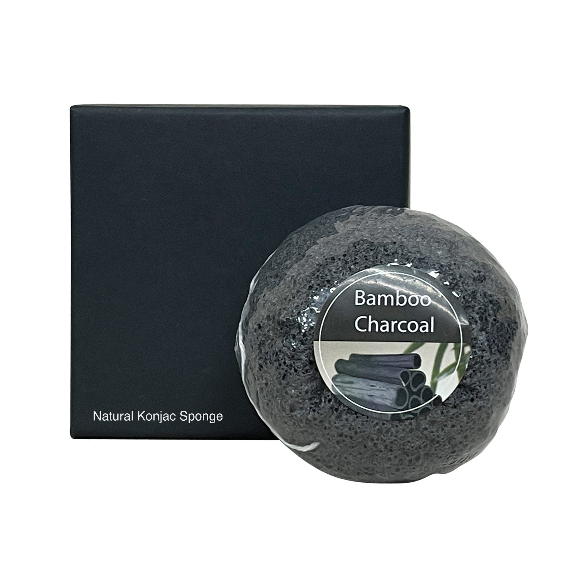 A black konjac sponge with a "Bamboo Charcoal" label next to a black box.