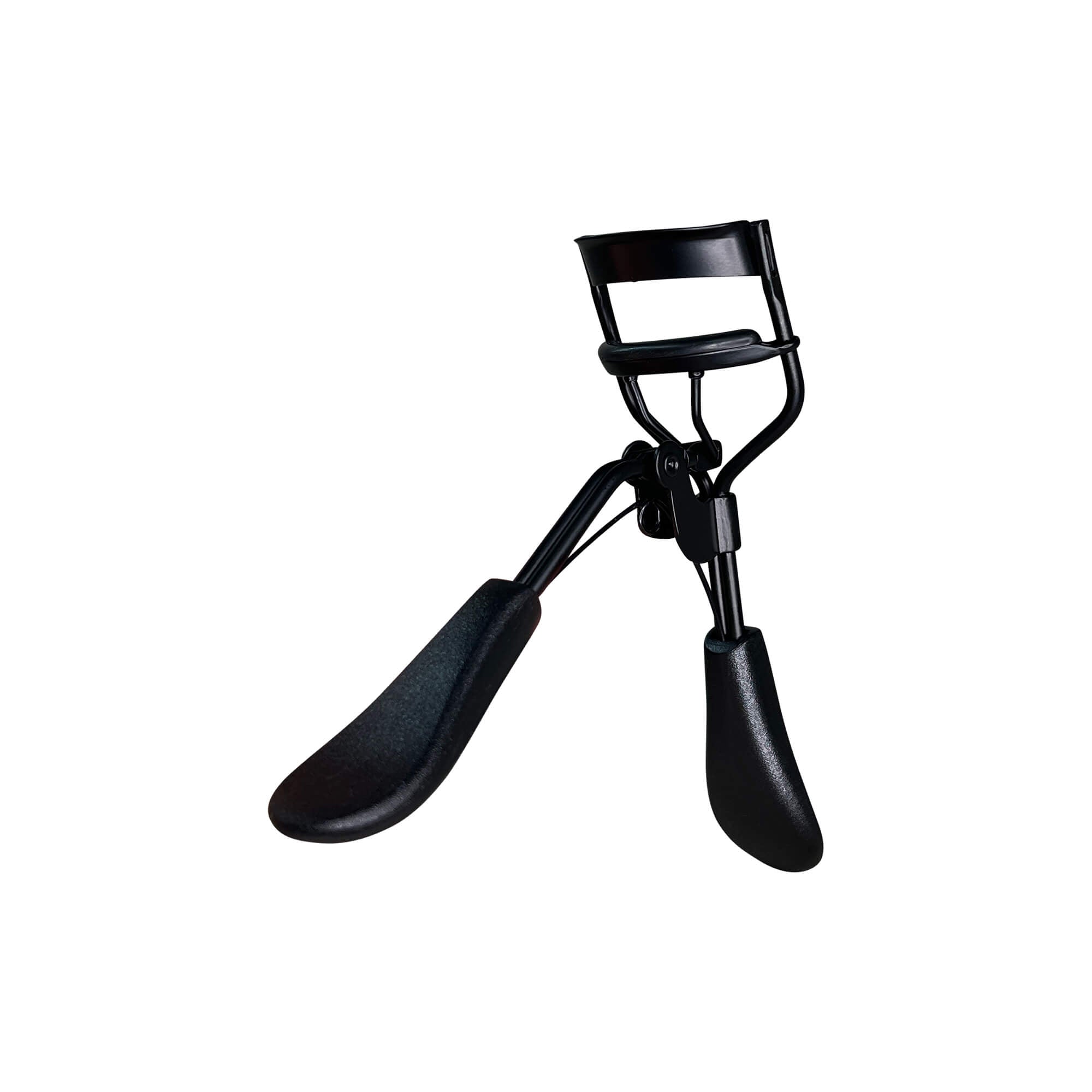 A black padded eyelash curler is angled on a white background.