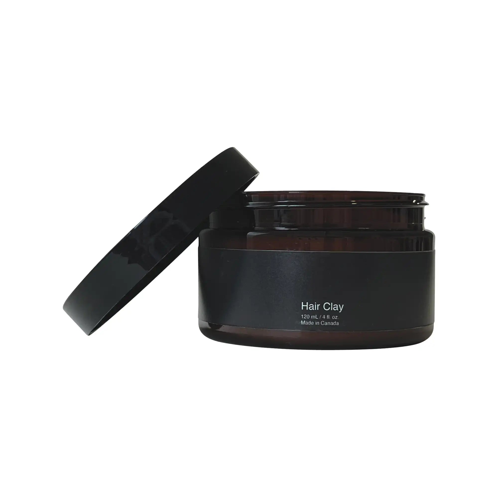 An open amber jar of Hair Clay with a black label and lid.
