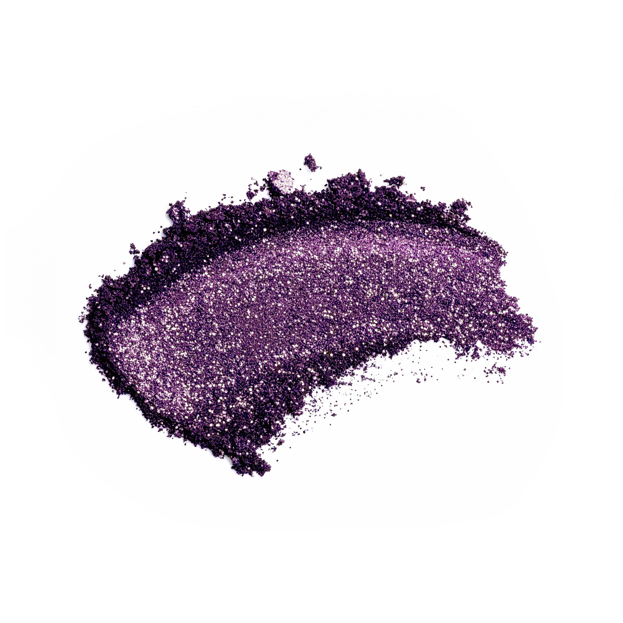 A swatch of amethyst glitter dust is spread across a white background.