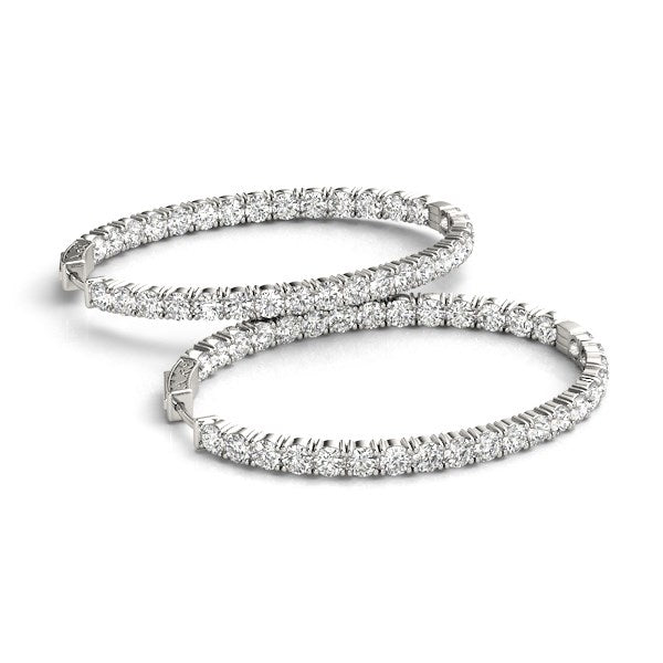 Two oval-shaped, two-sided diamond hoop earrings in 14k white gold.