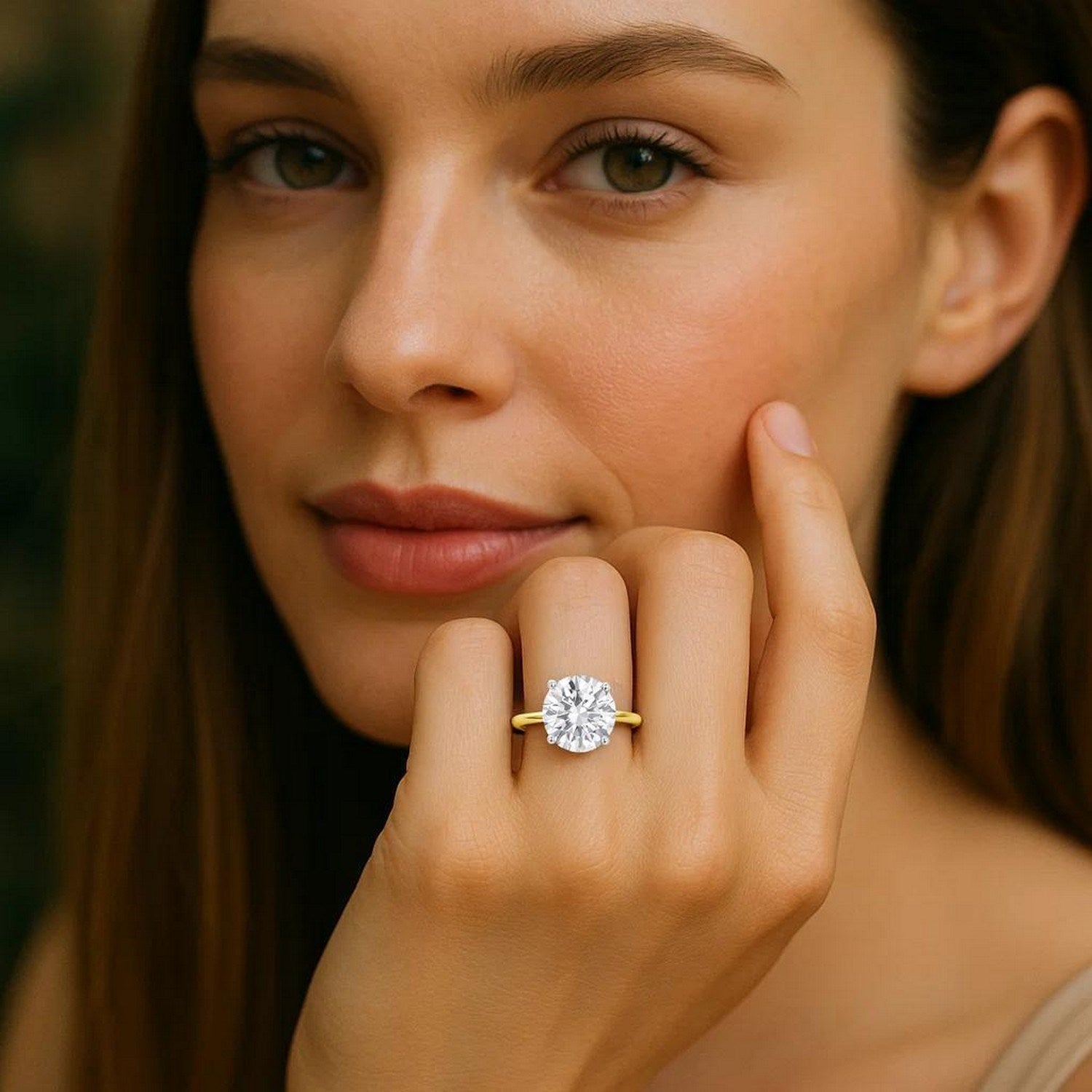 A woman wears a 5 carat round lab grown diamond solitaire ring in 10K yellow gold.