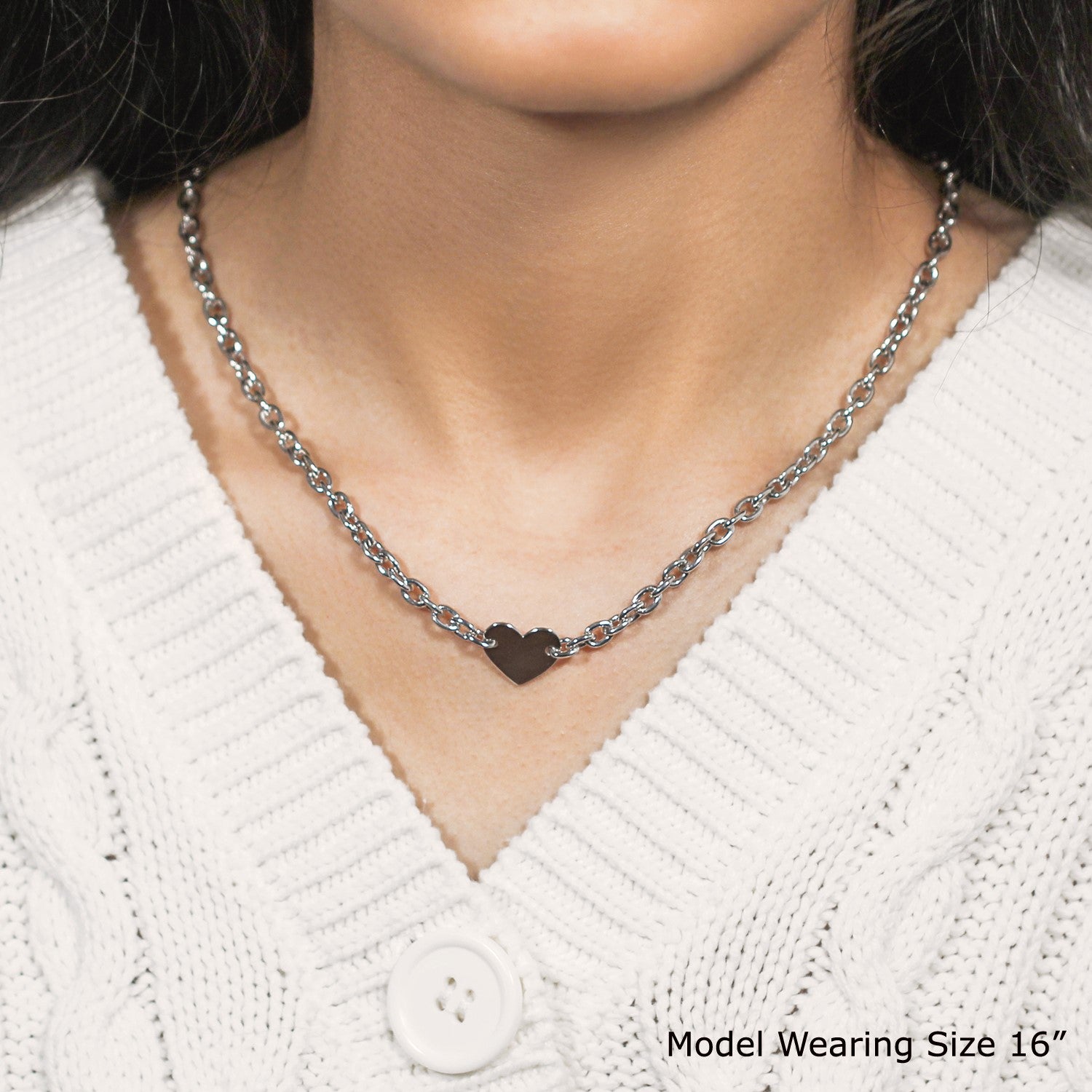 Sterling silver rhodium plated chain necklace with a flat heart motif station.