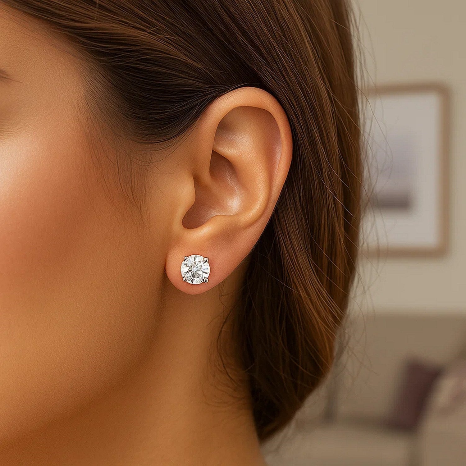 Sterling silver stud earring with a 6mm round white cubic zirconia in a four-prong setting.