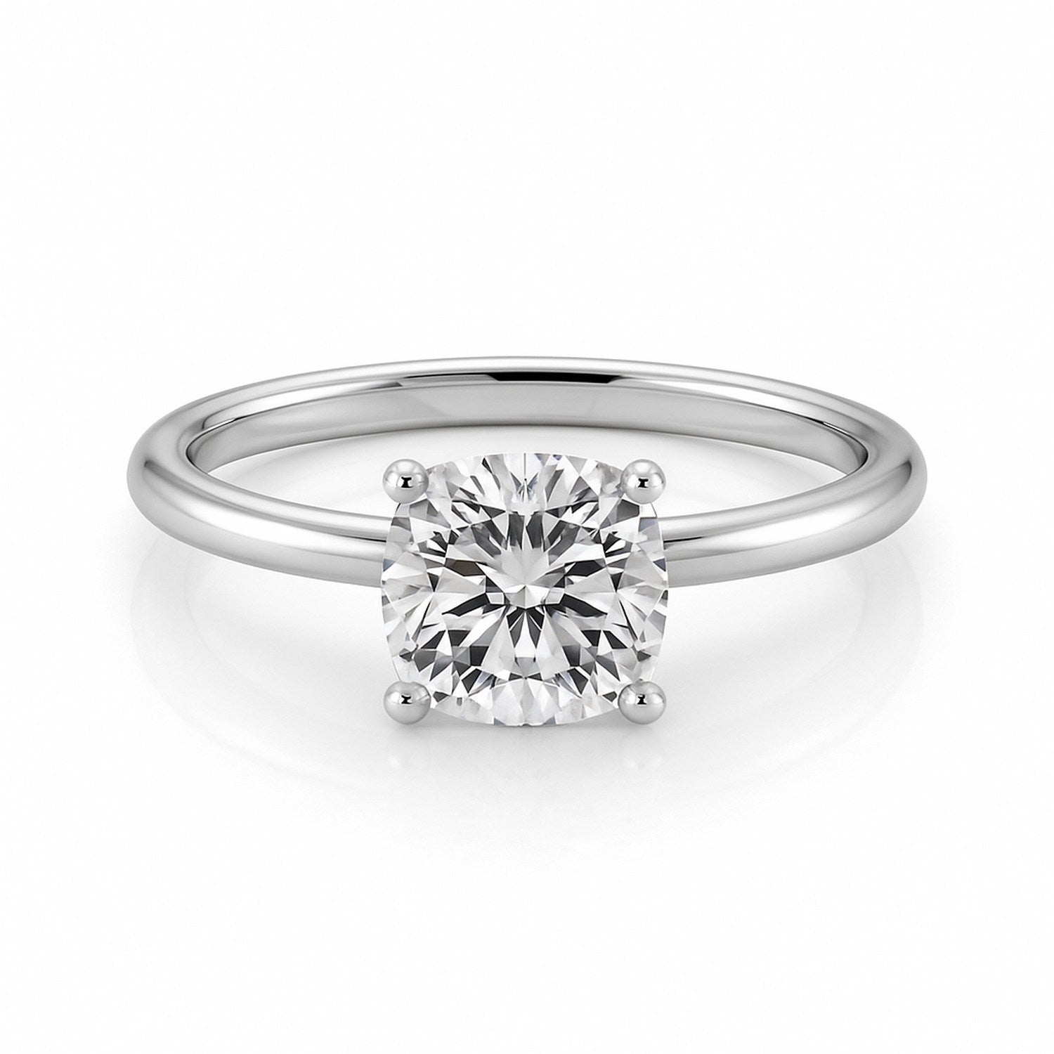 A 1 1/2 carat cushion lab-grown diamond solitaire ring in 14K white gold.