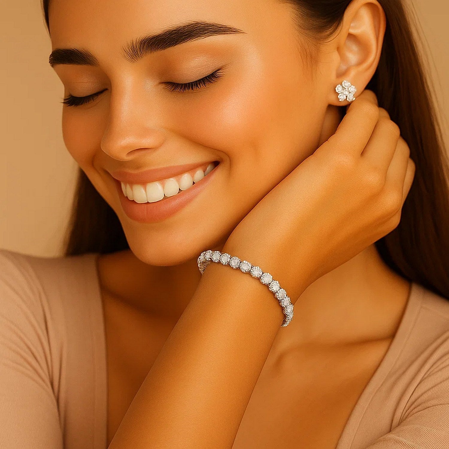 A woman smiles, wearing a lab grown round diamond tennis bracelet and matching stud earrings.