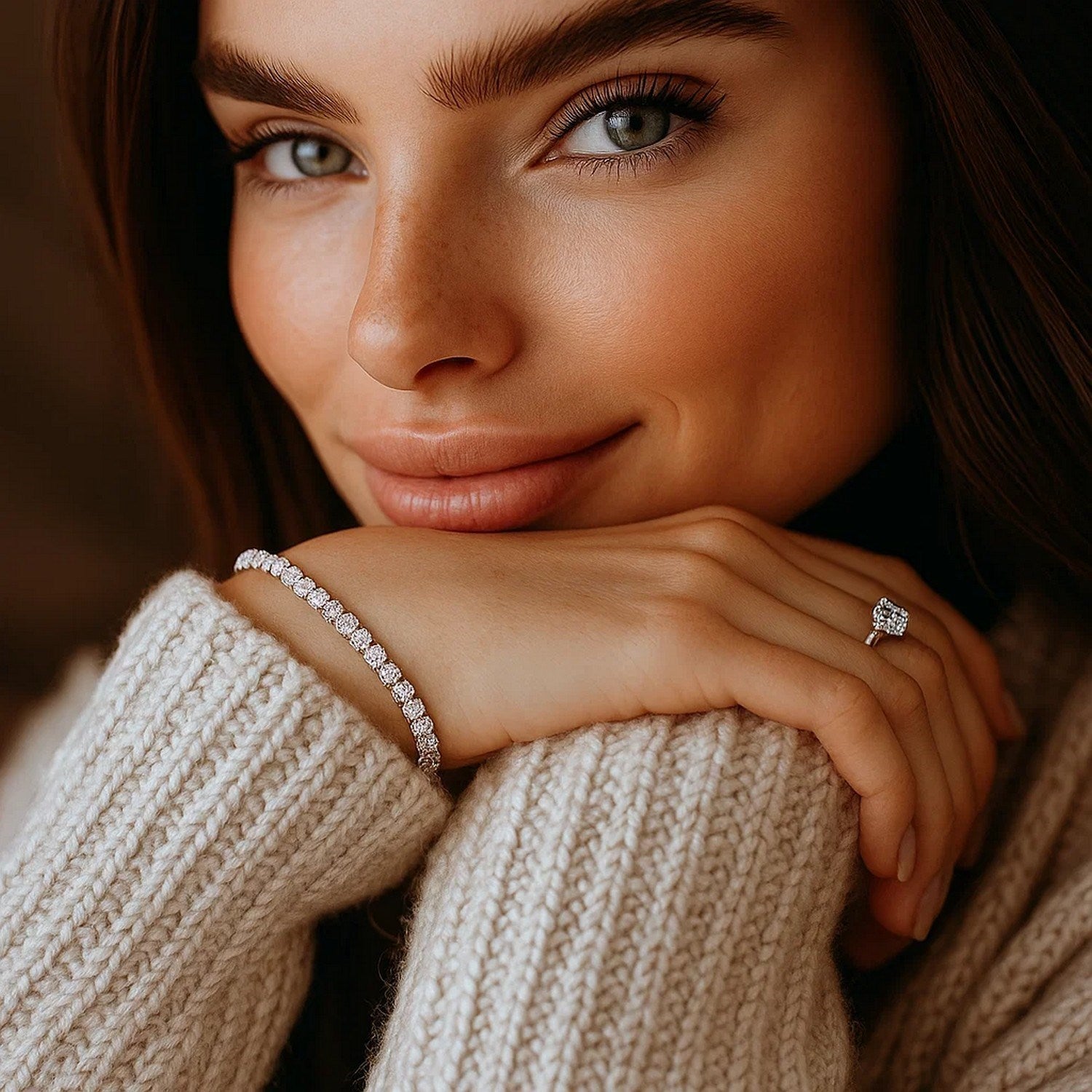 A woman wearing a lab grown round diamond tennis bracelet and a diamond ring.