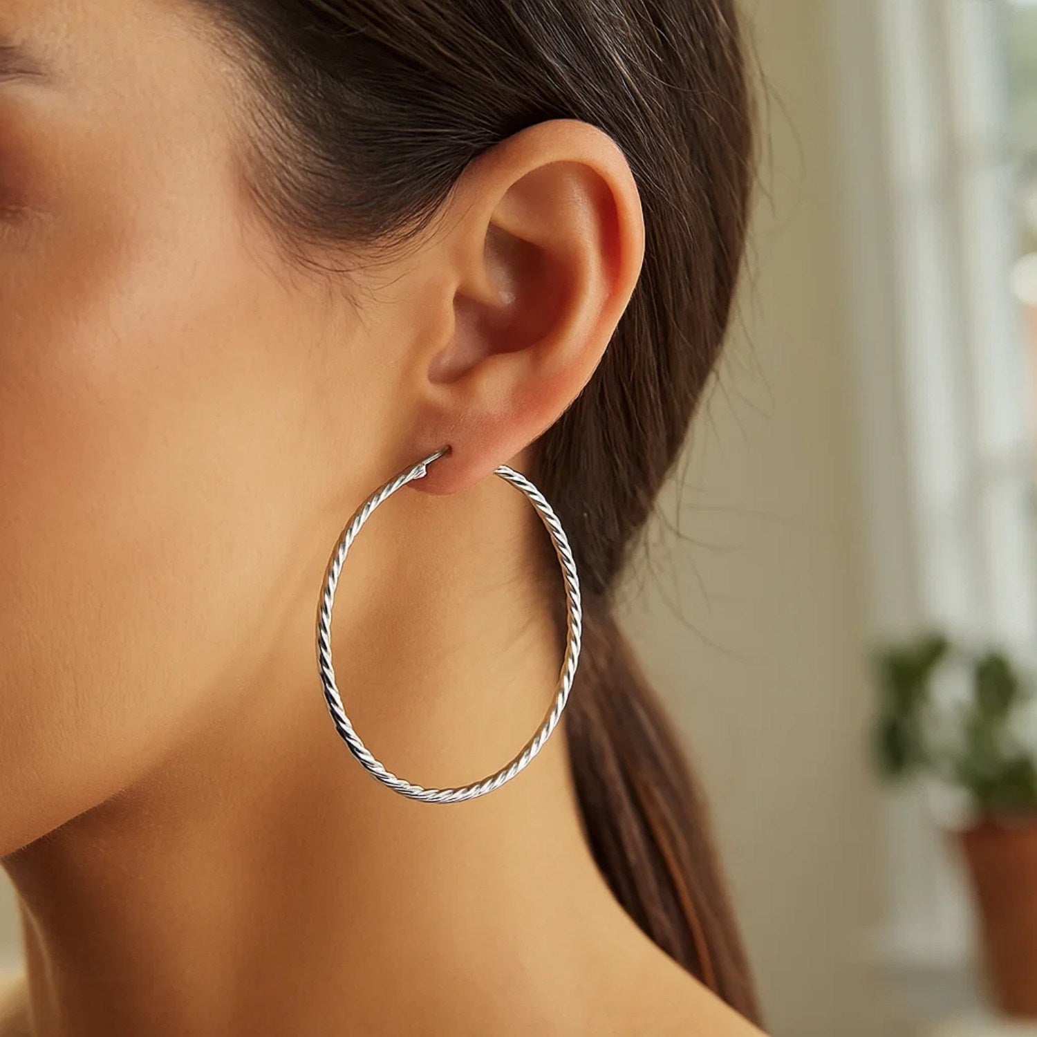 Sterling silver hoop earrings with a twist texture.