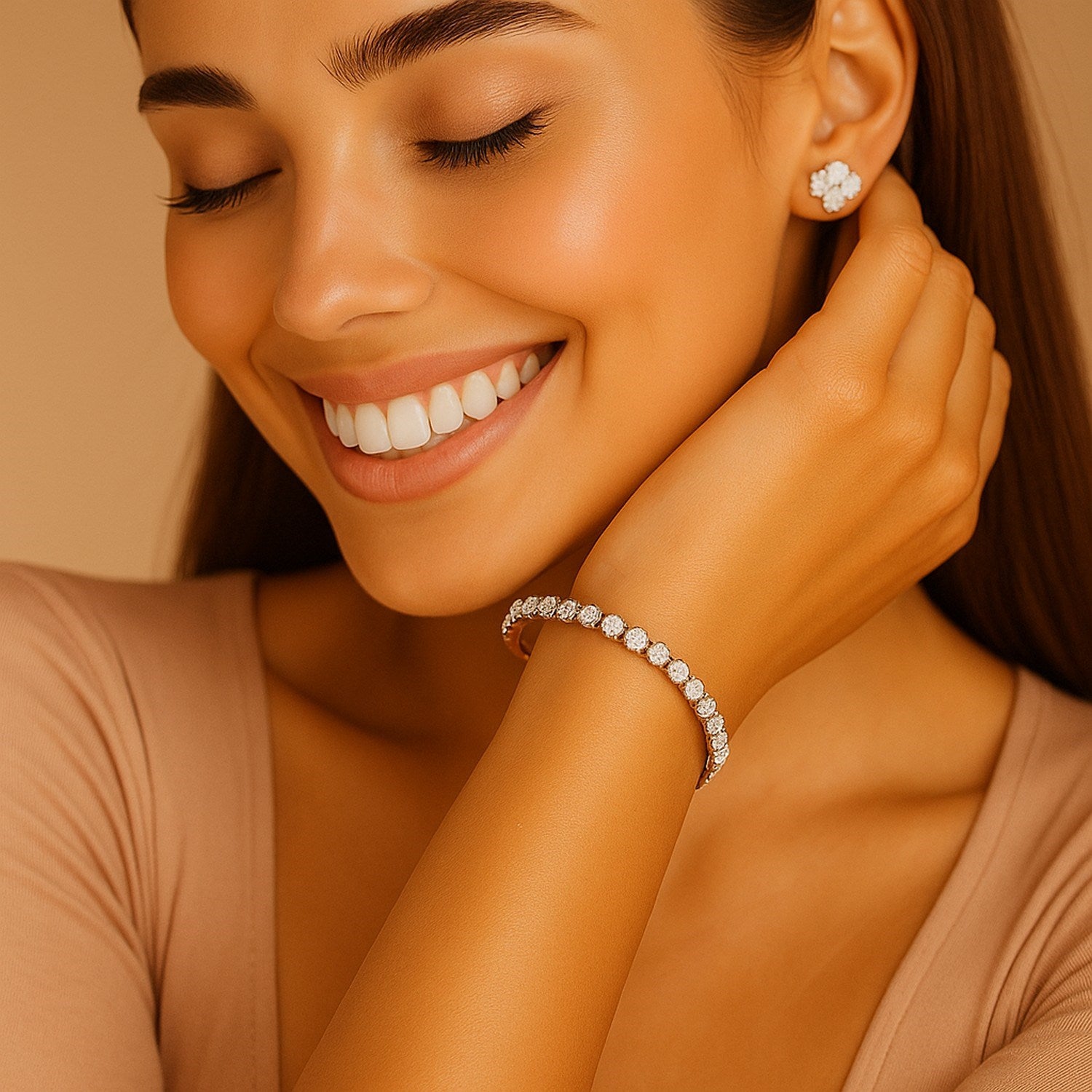 A woman smiles, wearing a lab grown round diamond tennis bracelet and flower stud earrings.
