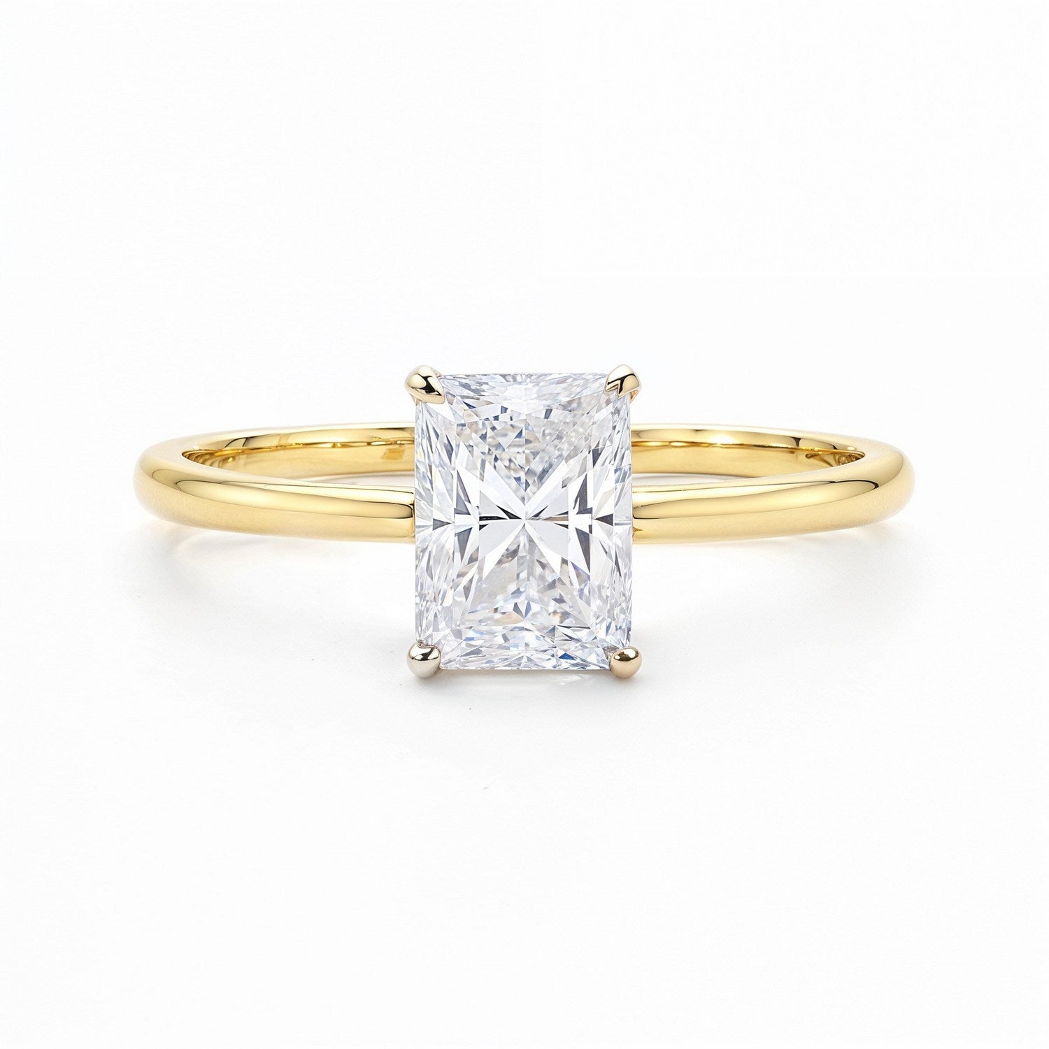 Radiant lab-grown diamond ring with a yellow gold band on a white background.