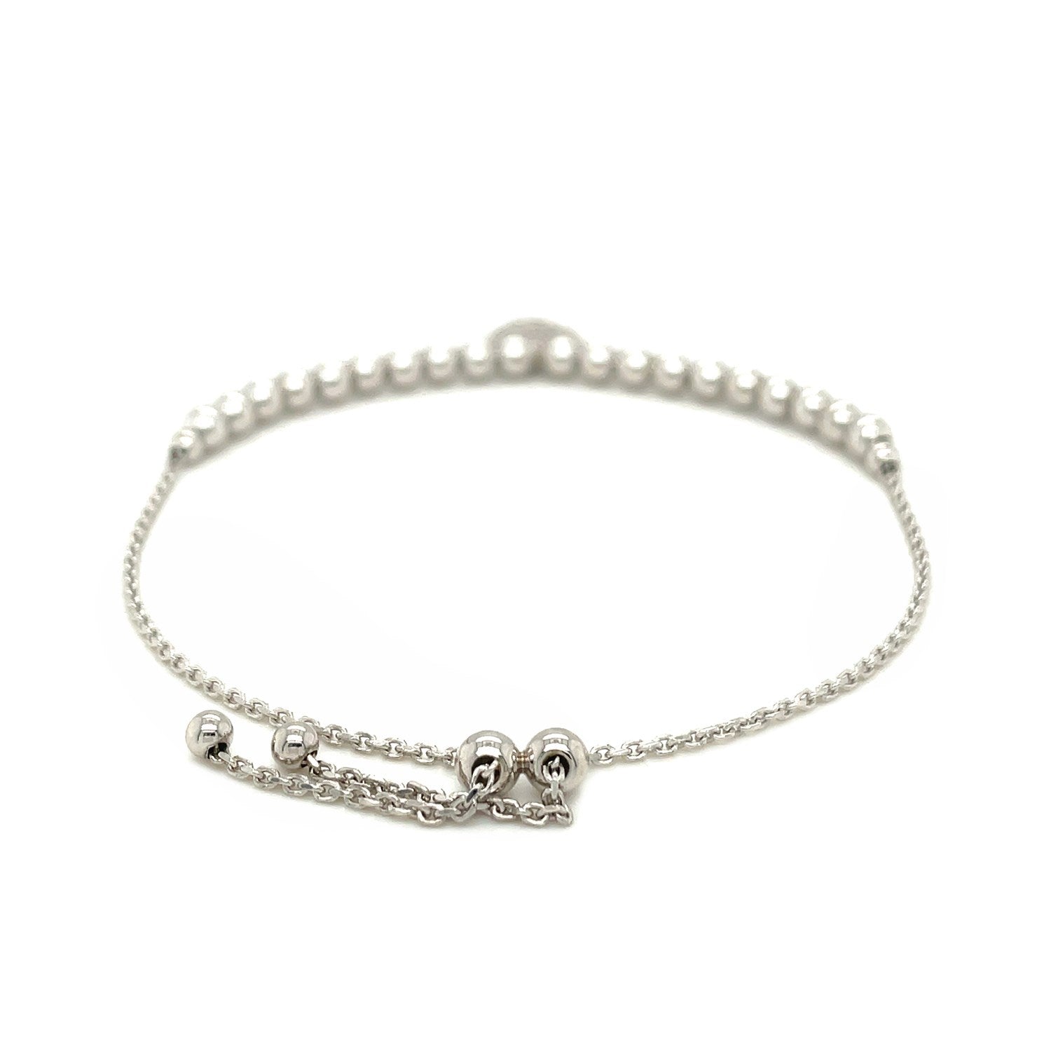 Adjustable sterling silver bead bracelet with a round charm and cubic zirconias.