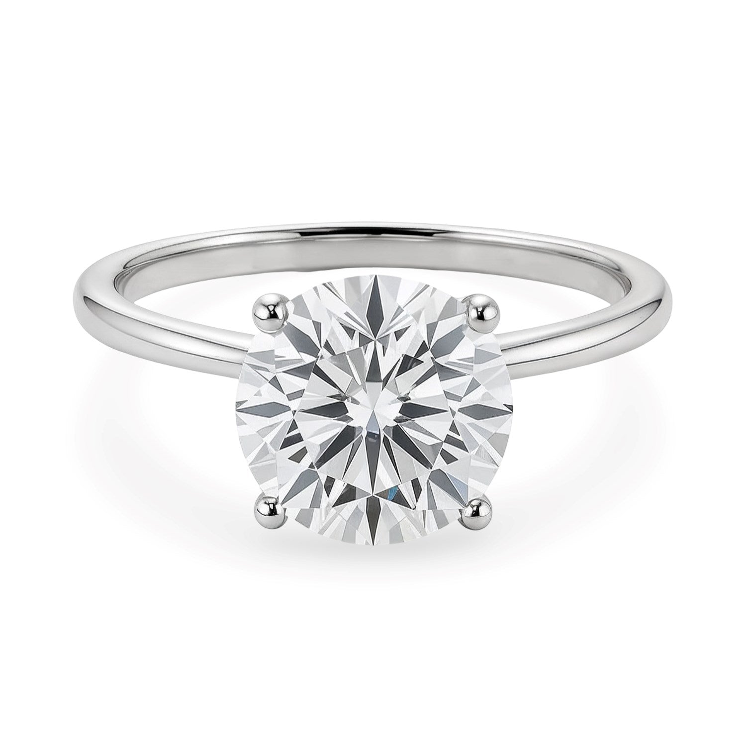 A sterling silver solitaire ring features a round, brilliant-cut diamond in a four-prong setting.