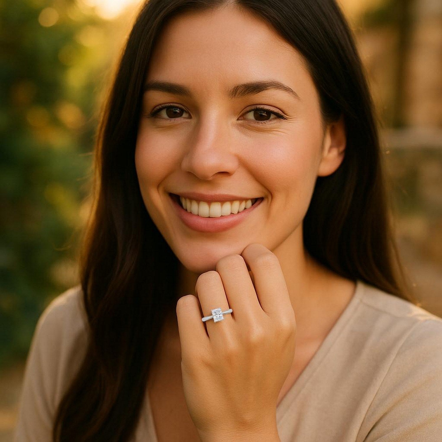 A woman smiles, wearing a radiant lab grown diamond solitaire ring in 14K white gold.