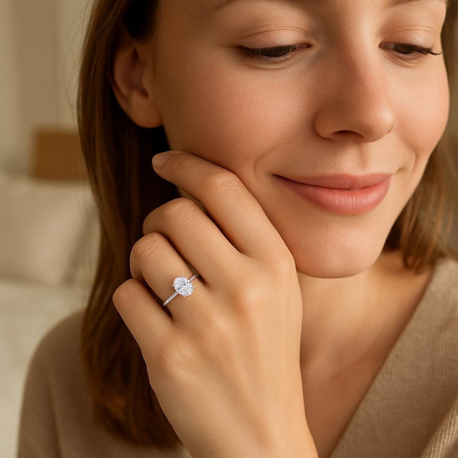 A woman wears a 1 carat oval lab grown diamond solitaire ring in 10K white gold.