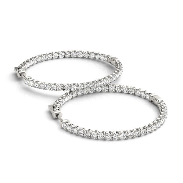 Two 14k white gold diamond hoop earrings with shared prong settings.