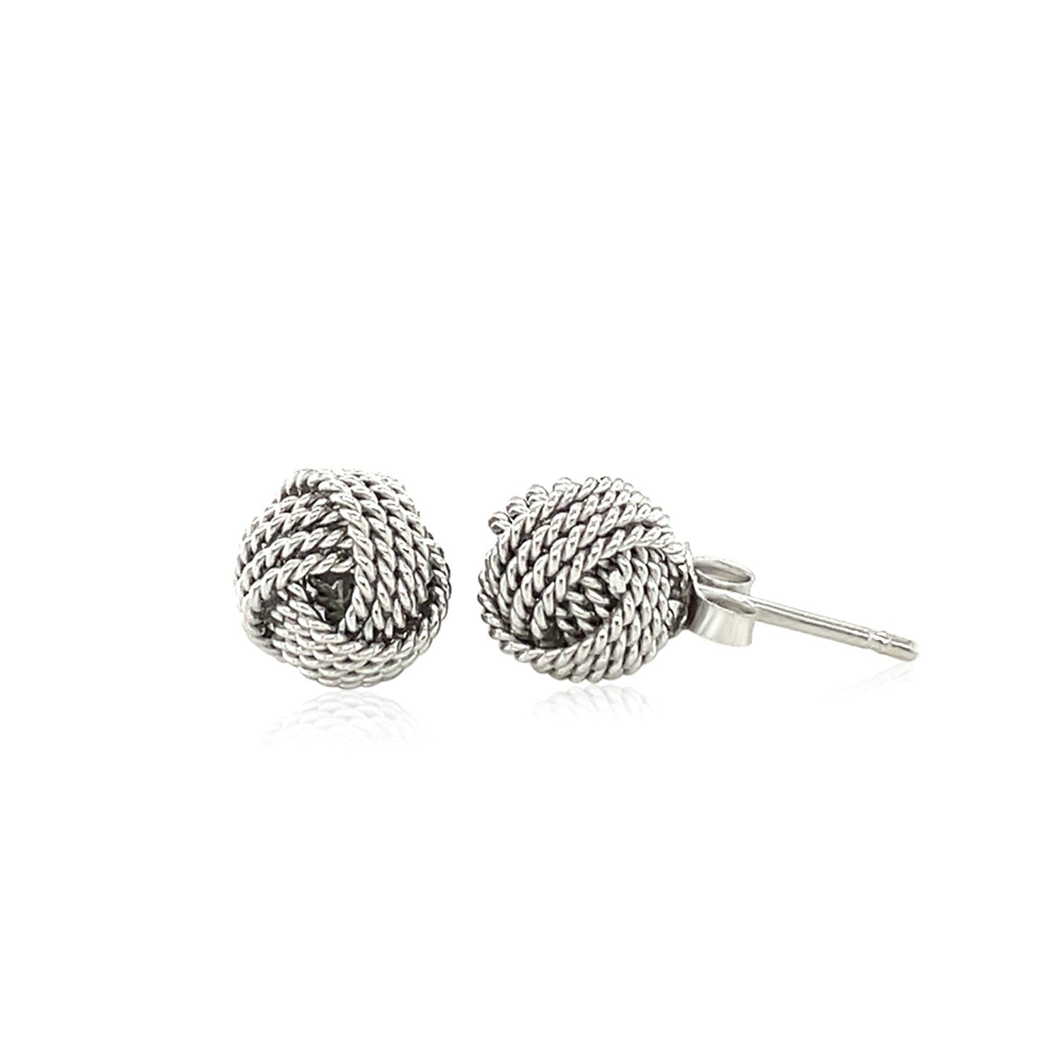 Sterling silver textured love knot stud earrings with a push-back closure.