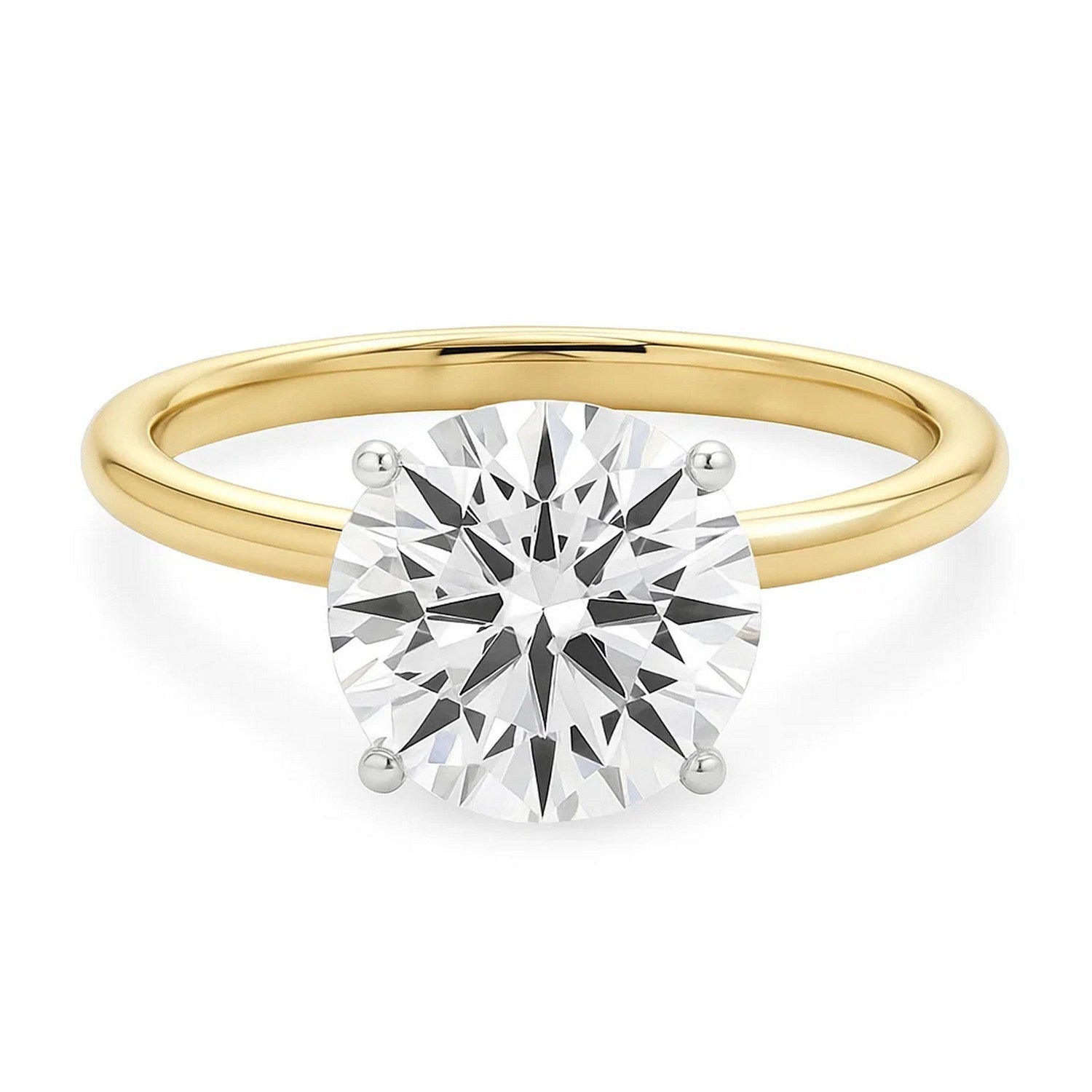 A round lab-grown diamond solitaire ring with white gold prongs on a yellow gold band.
