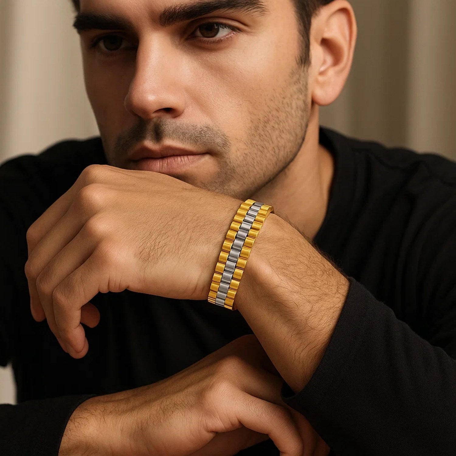 14k two-tone gold panther link bracelet on a man's wrist.