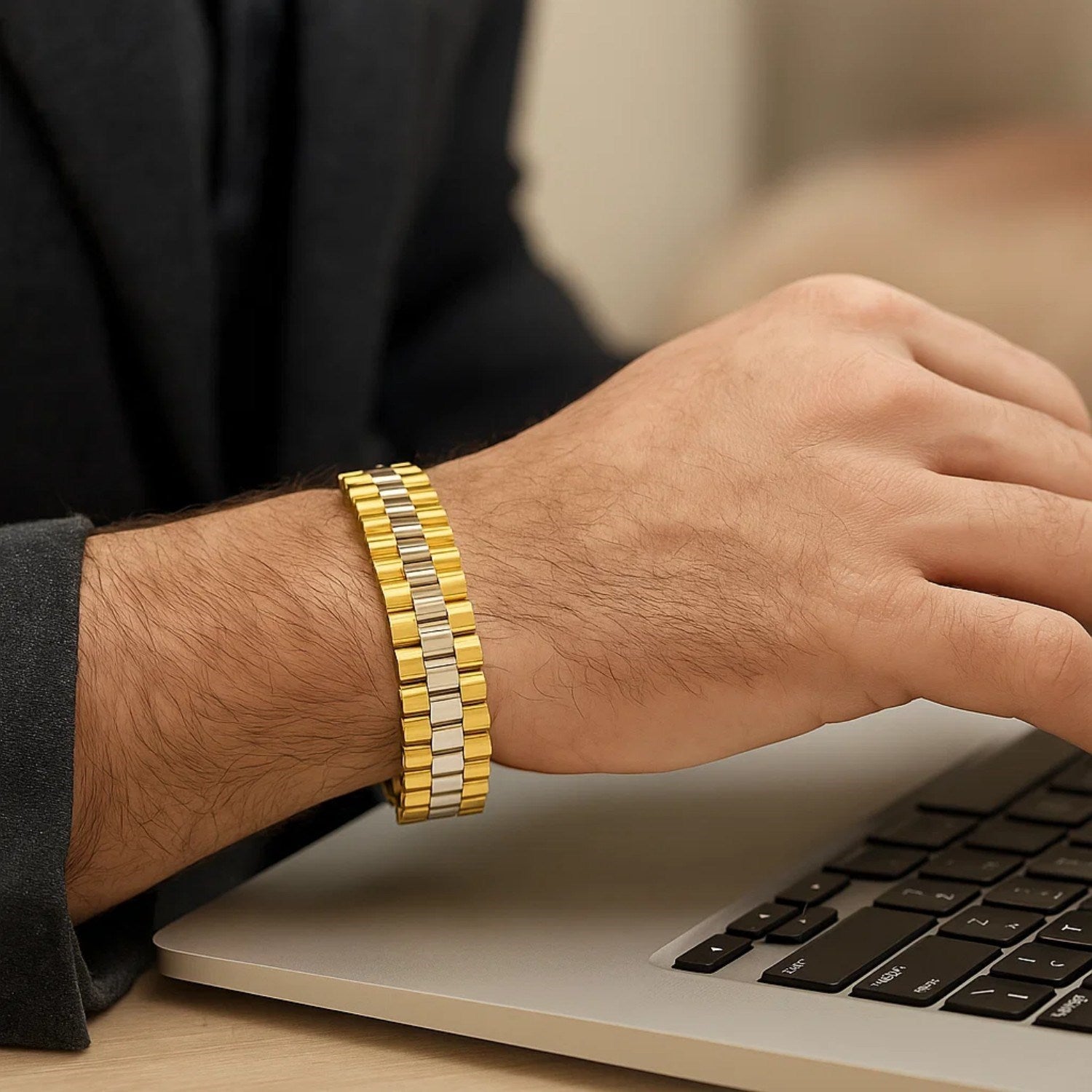 14k two-tone gold men's panther link bracelet on a wrist using a laptop.