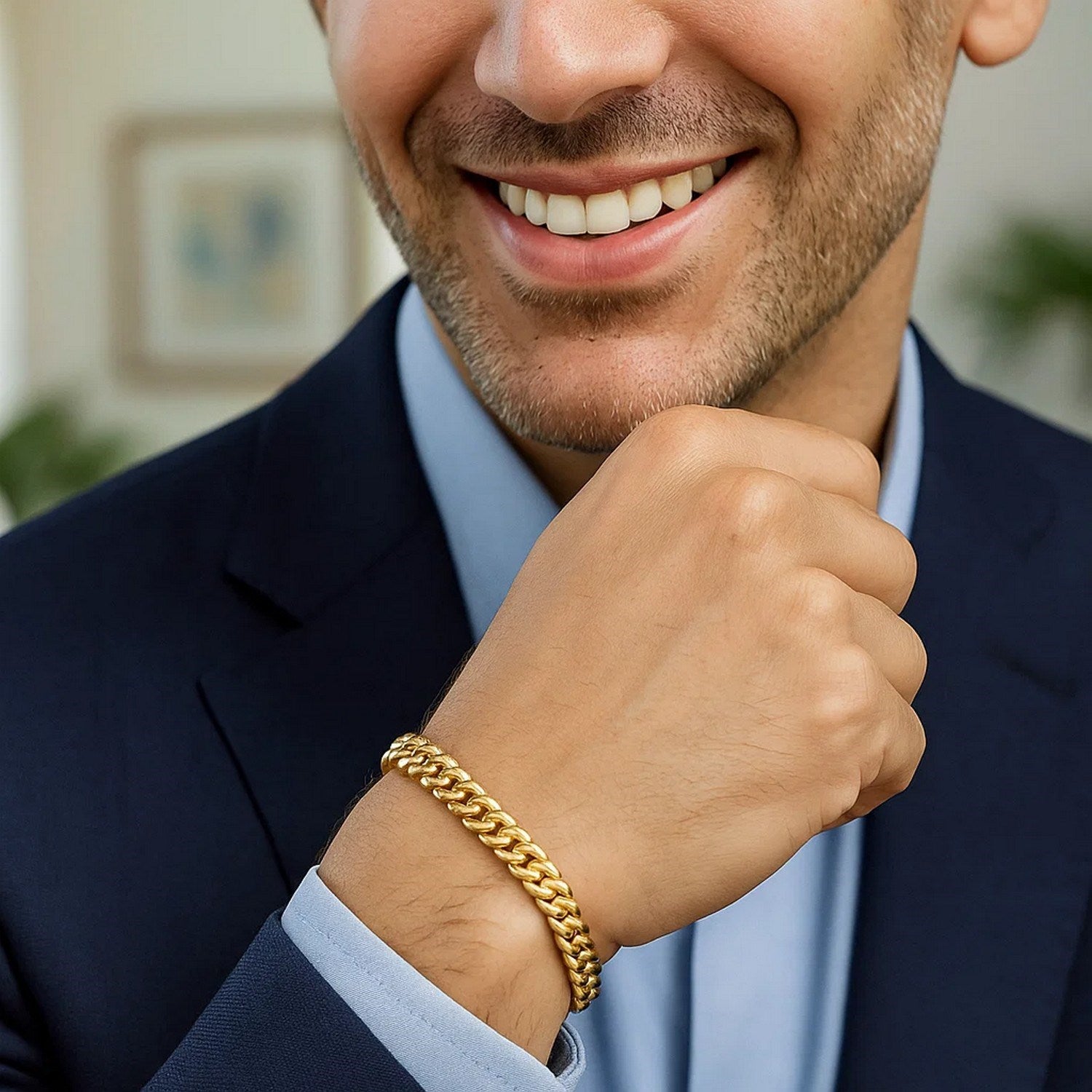 A man smiles while wearing a 14k yellow gold classic Miami Cuban solid bracelet.