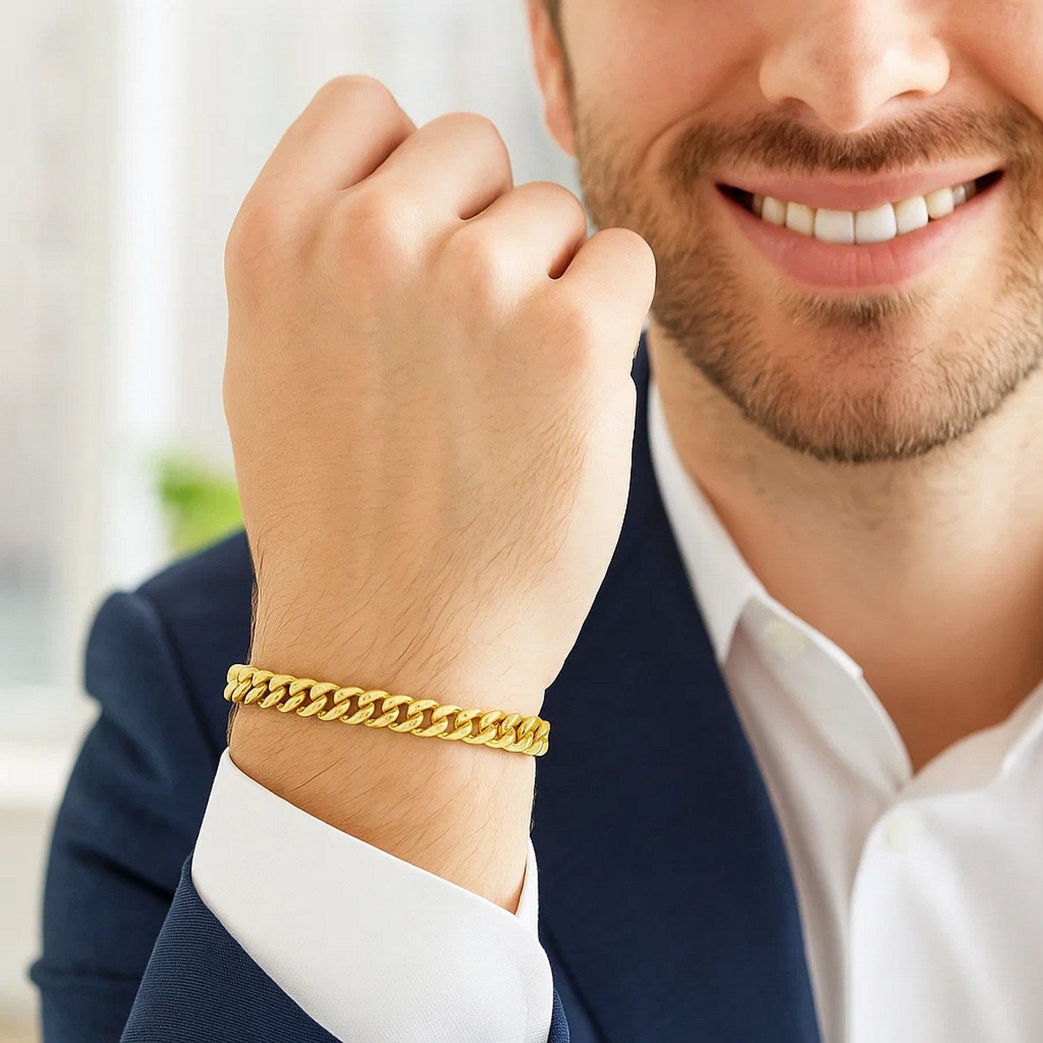 A man wearing a 14k yellow gold classic Miami Cuban solid bracelet.