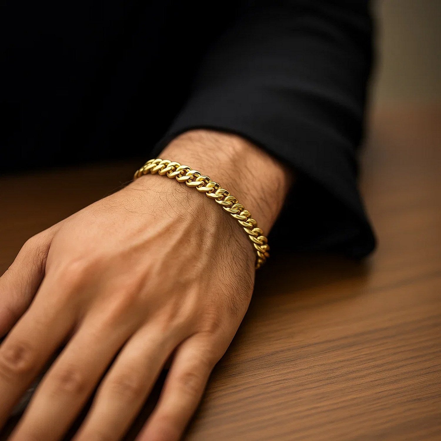 14k yellow gold classic Miami Cuban solid bracelet on a man's wrist.