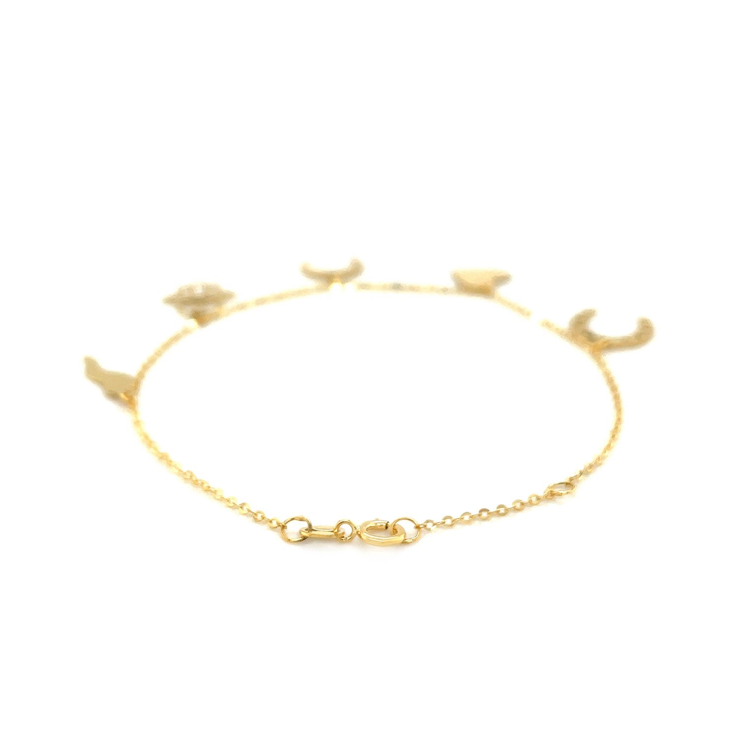 14k yellow gold bracelet with polished celestial and good luck charms.