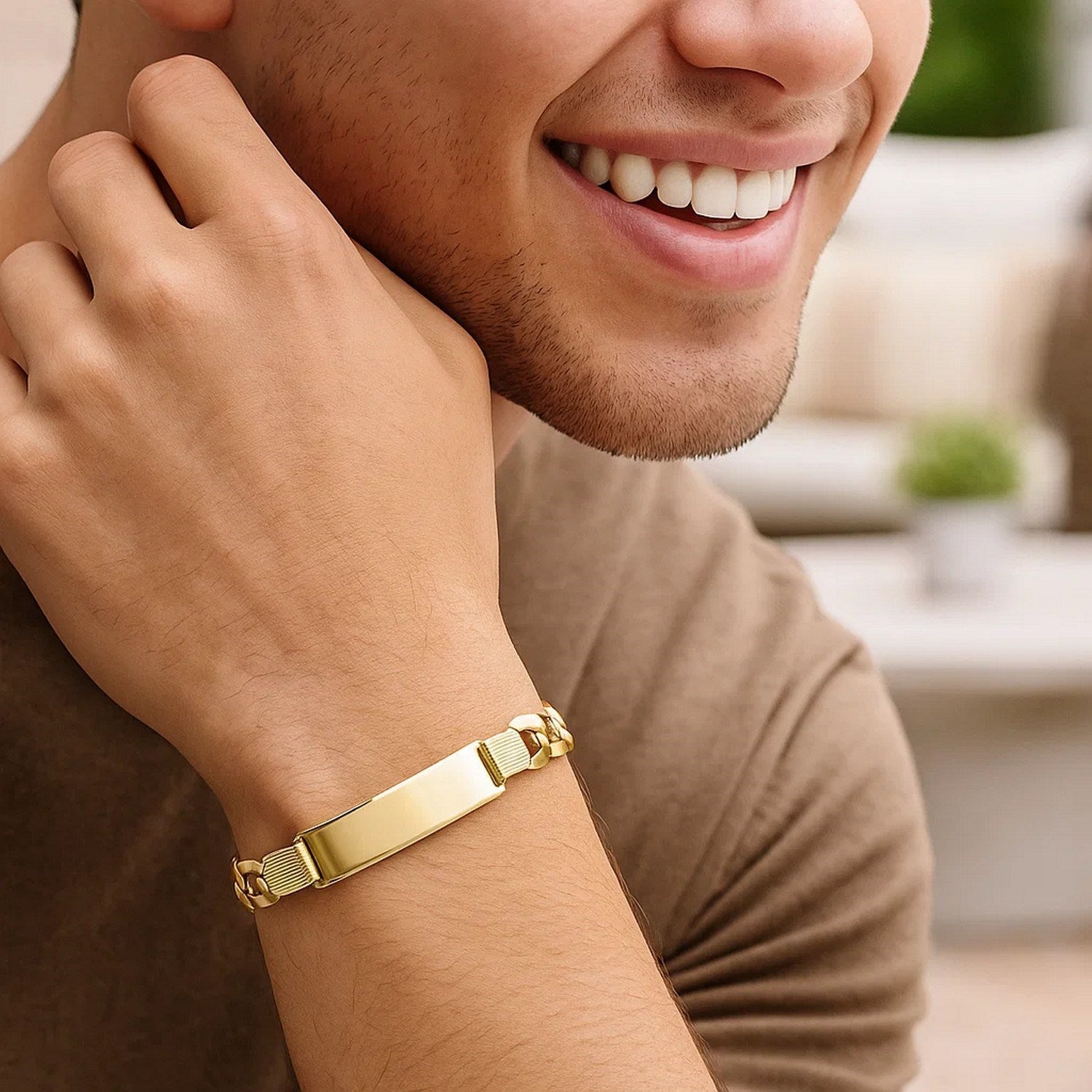 14k yellow gold curb ID bracelet on a man's wrist.