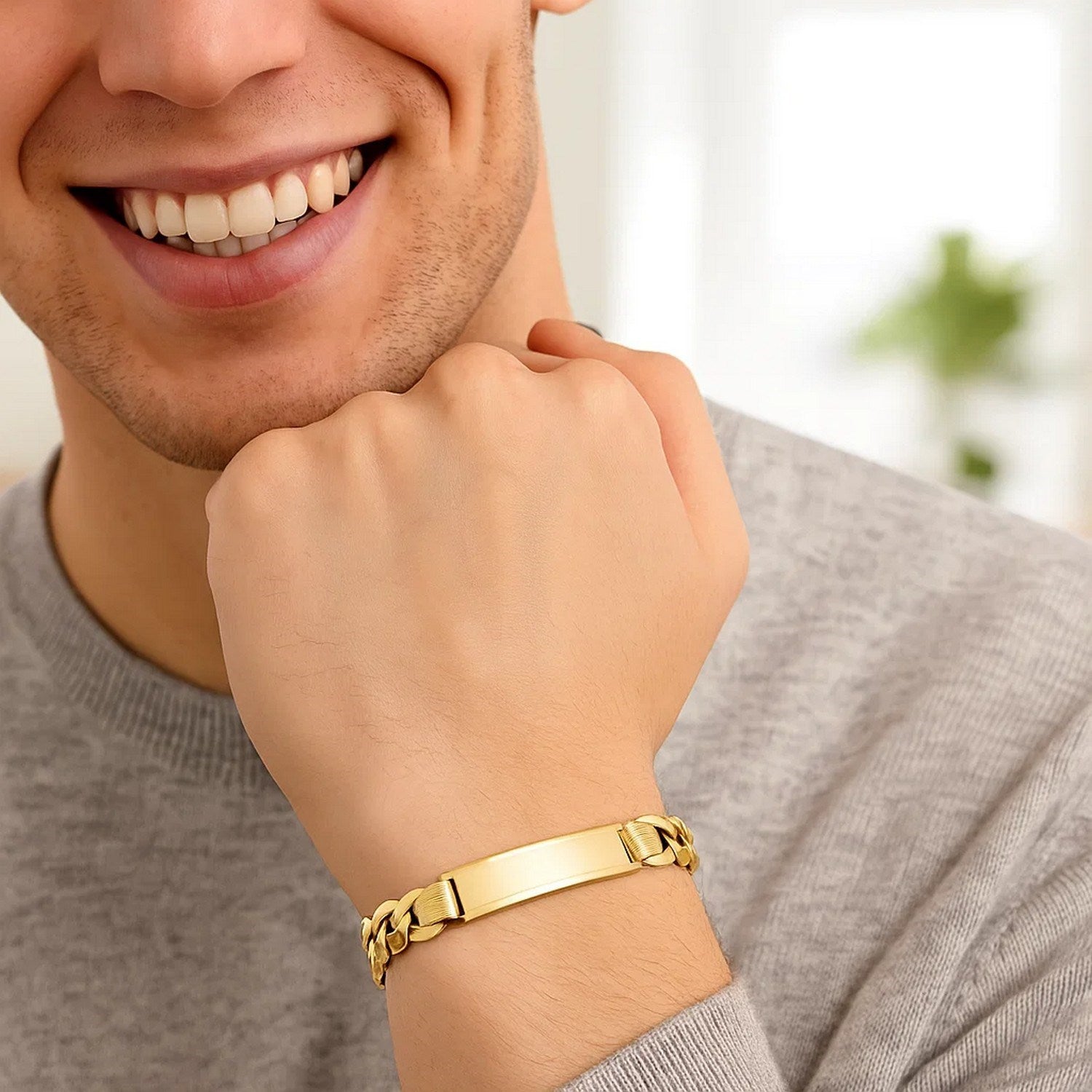 14k yellow gold curb ID bracelet on a man's wrist.