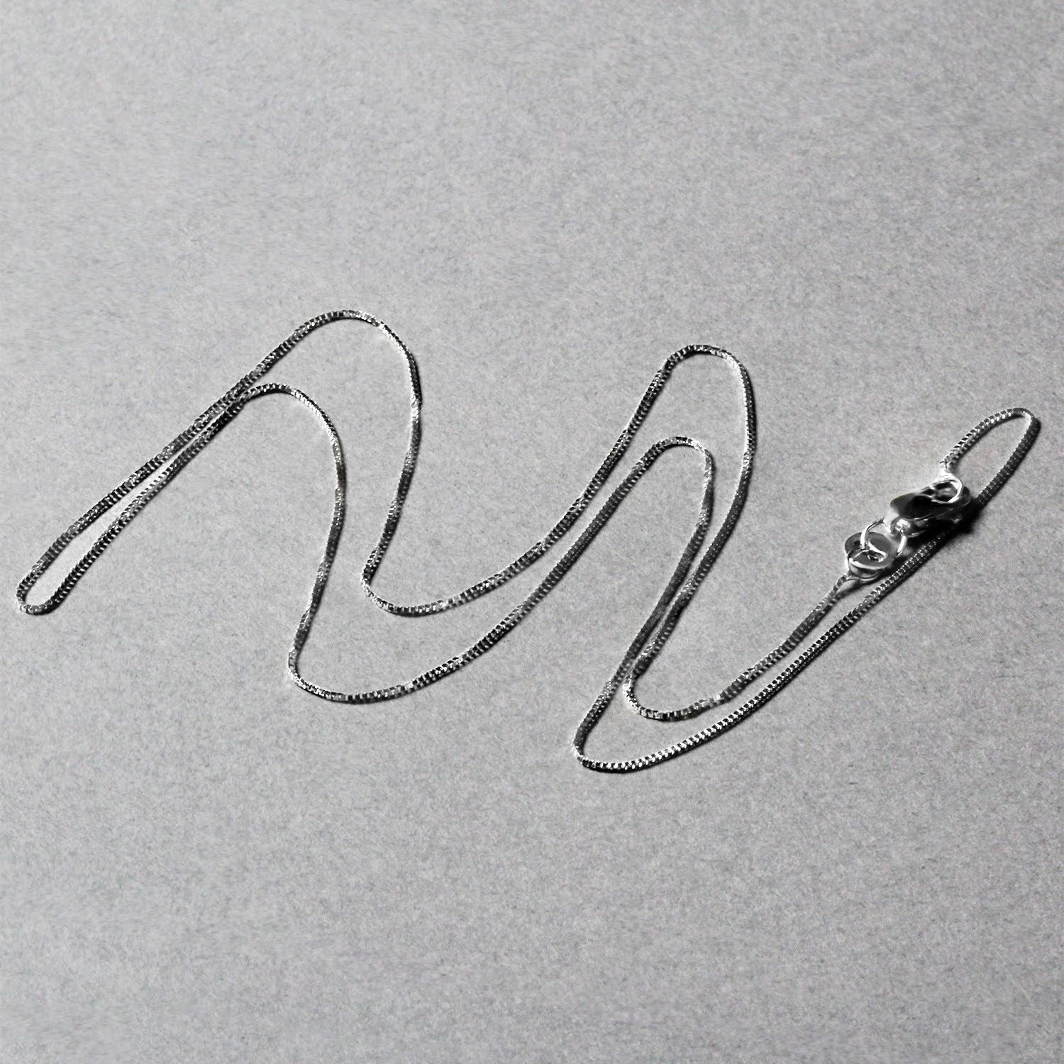 A delicate 10k white gold box chain with a lobster clasp.