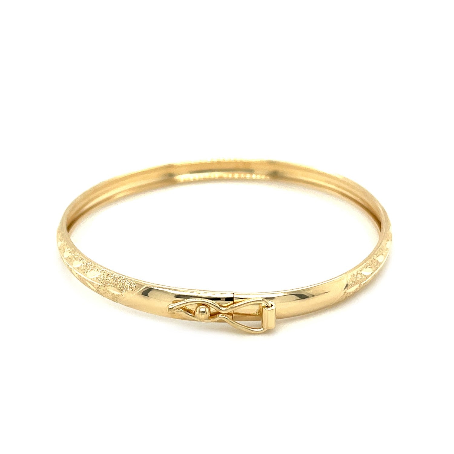 A 10k yellow gold children's bangle with a diamond-cut Florentine pattern.