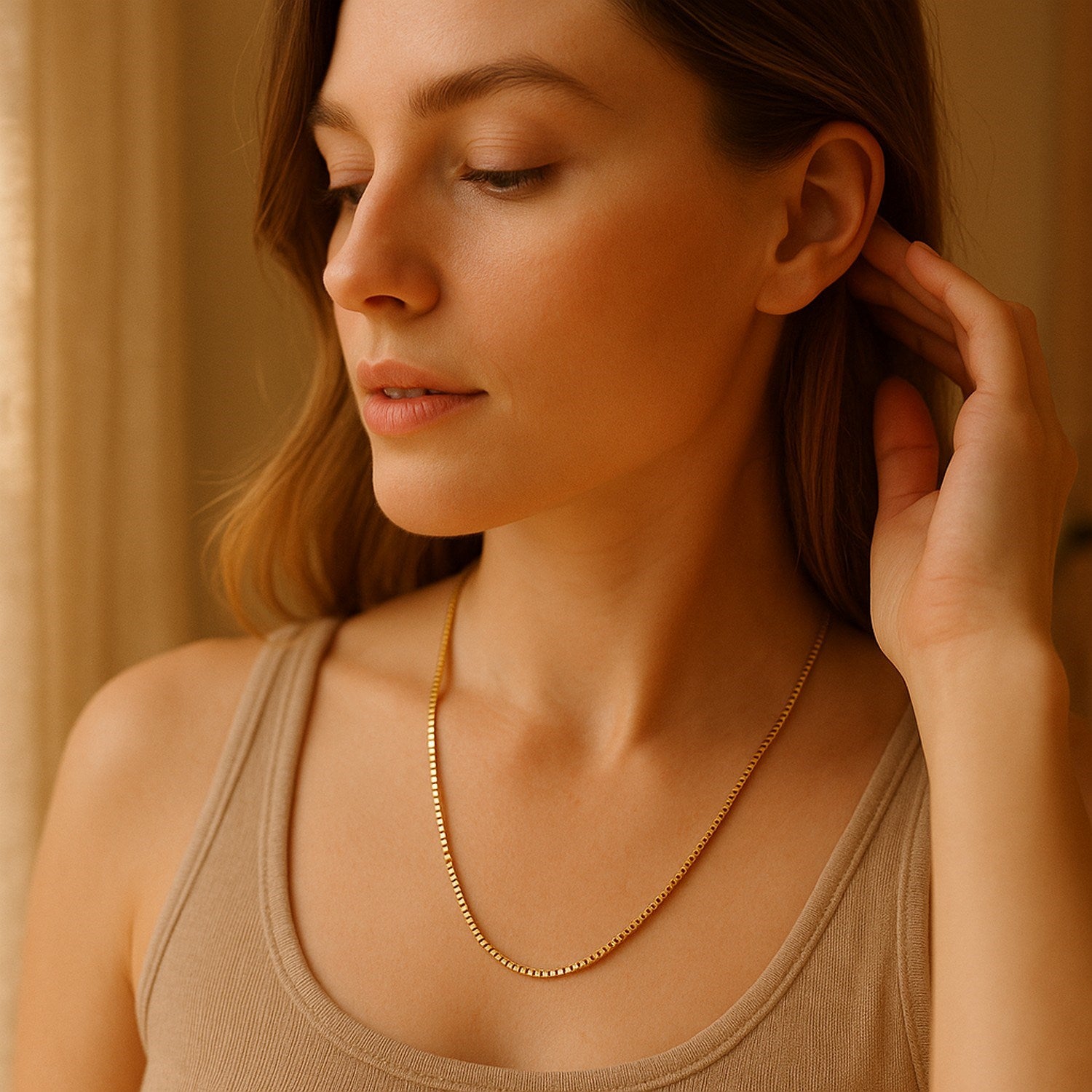 A 14k yellow gold semi-solid box chain on a woman's neck.