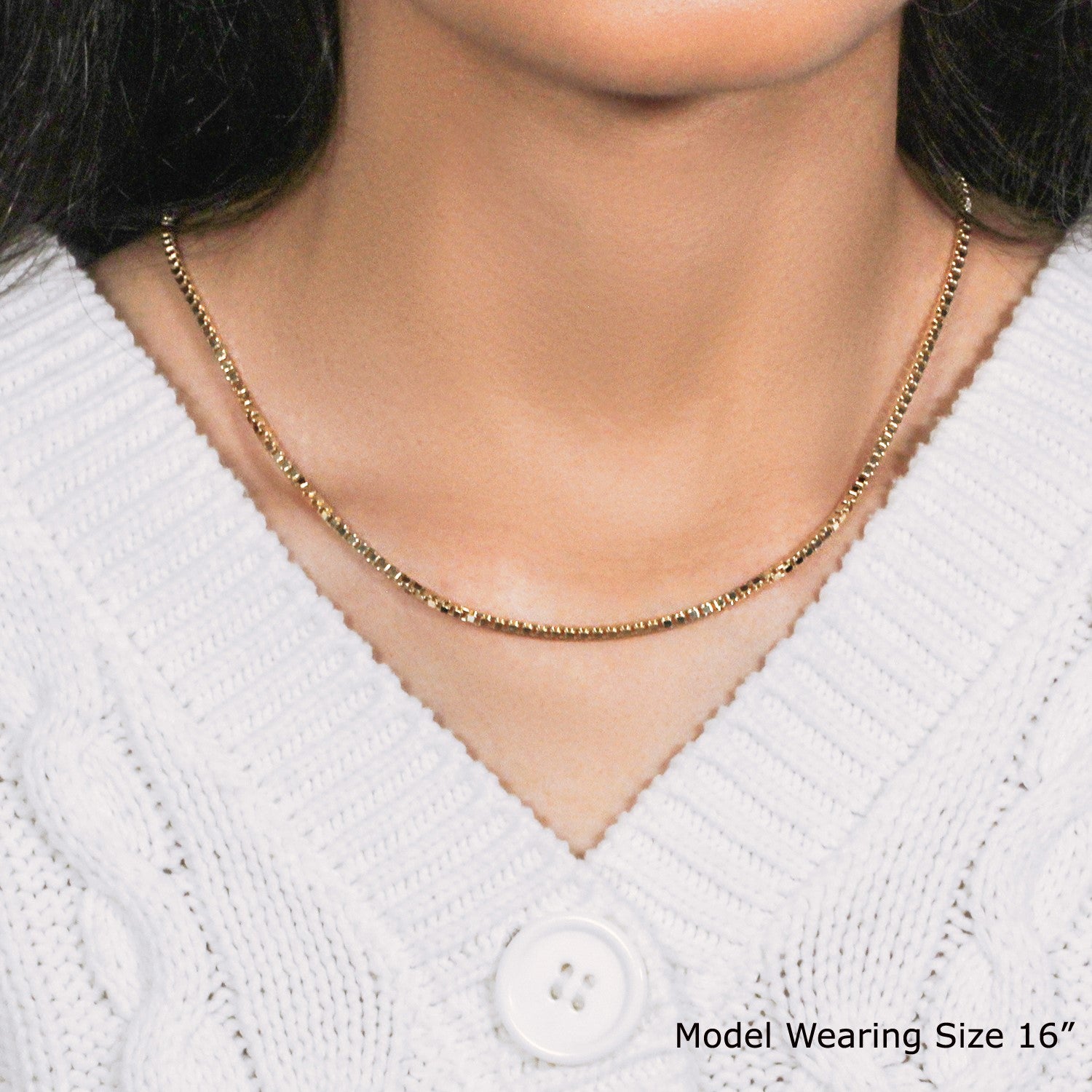 14k yellow gold semi-solid box chain on a model wearing a white sweater.