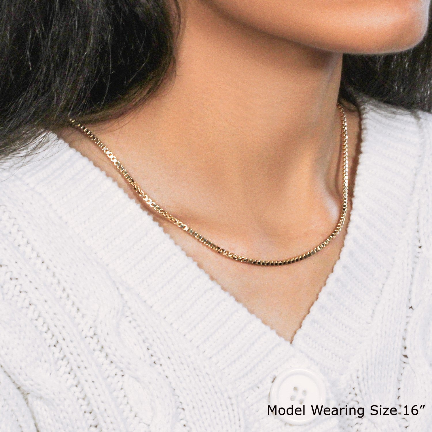 A woman wears a 14k yellow gold semi-solid box chain, 2.10 mm wide.