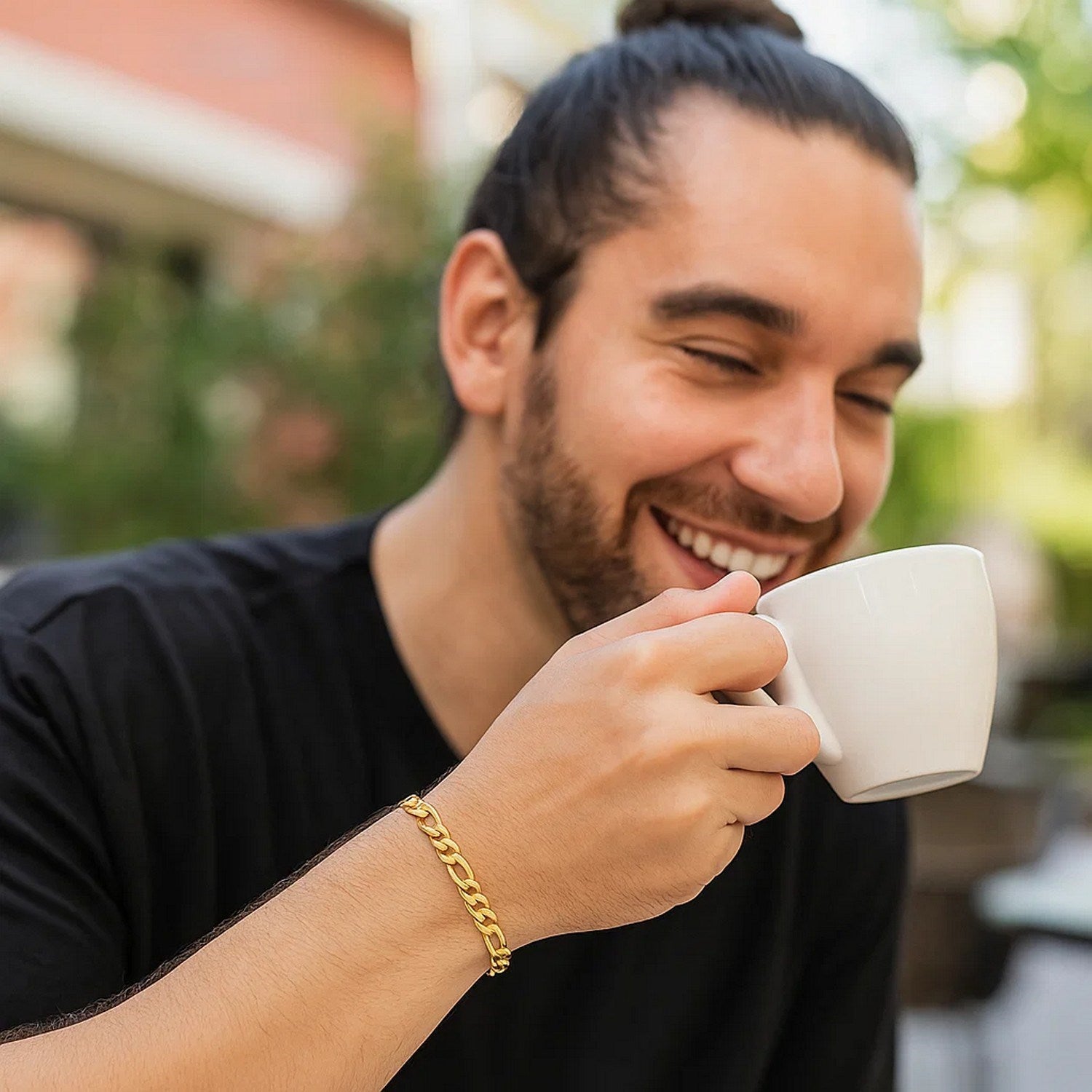 10k yellow gold Figaro link bracelet on a man's wrist.
