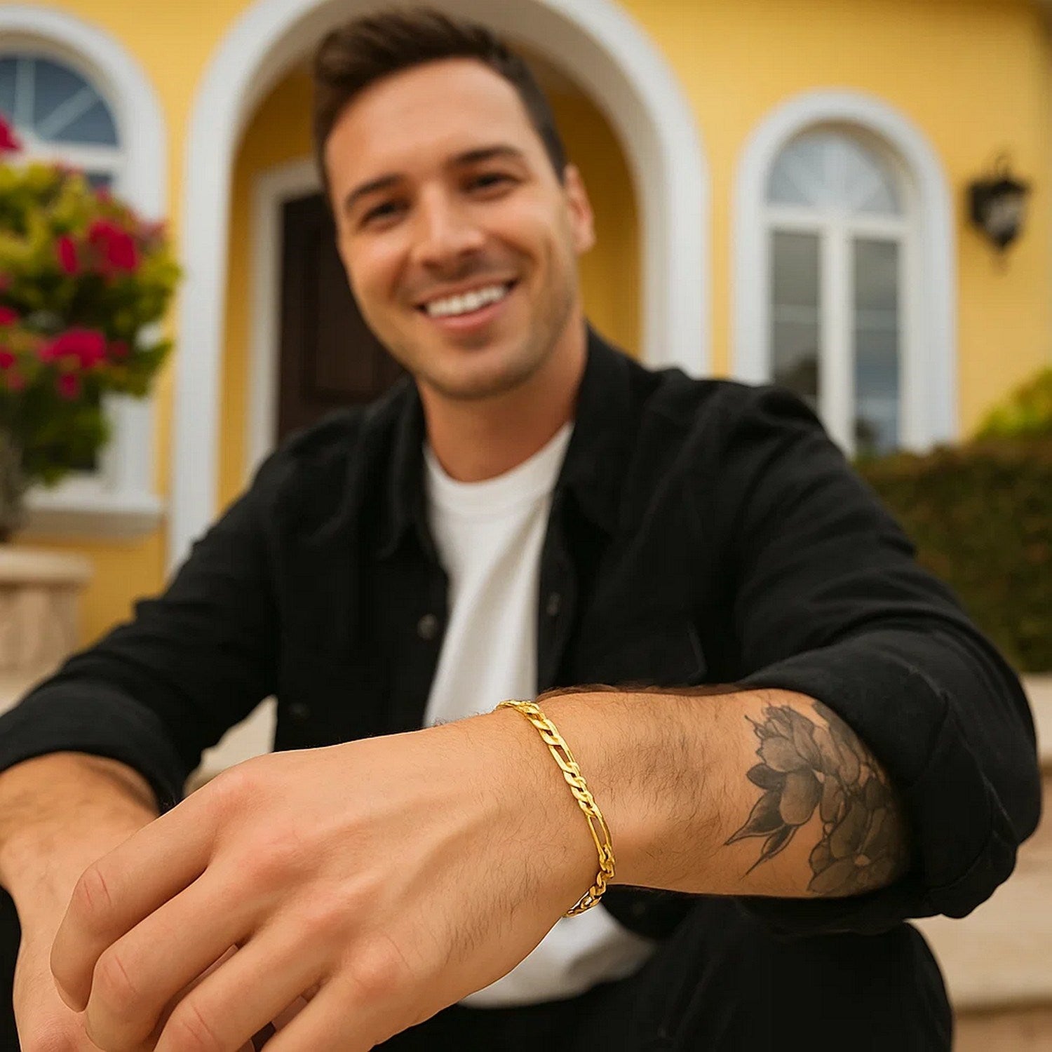 10k yellow gold Figaro link bracelet on a man's wrist.
