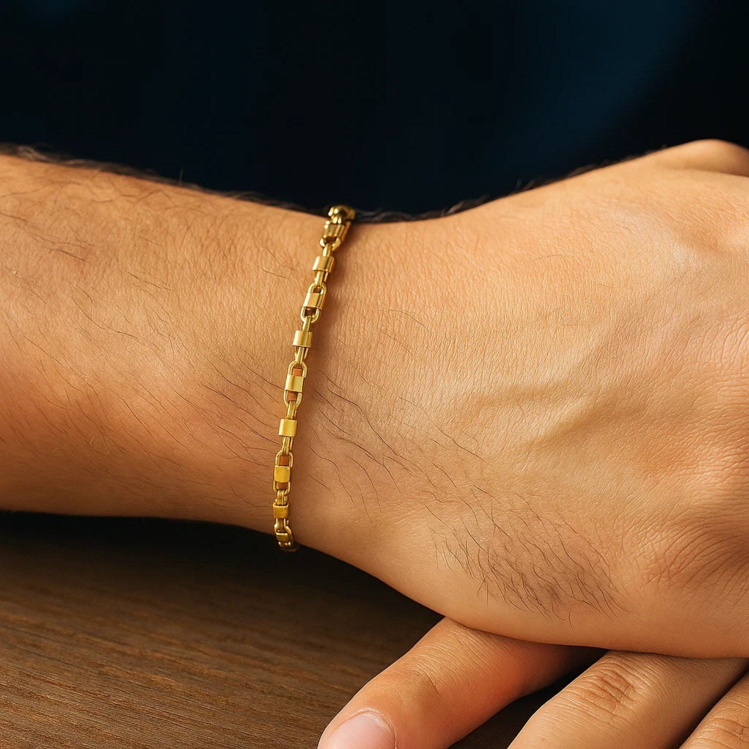 14K yellow gold square Byzantine chain bracelet on a person's wrist.