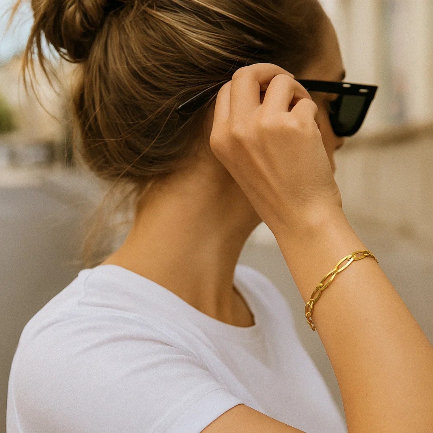 A 14k yellow gold Italian oval links bracelet is worn on a person's arm.