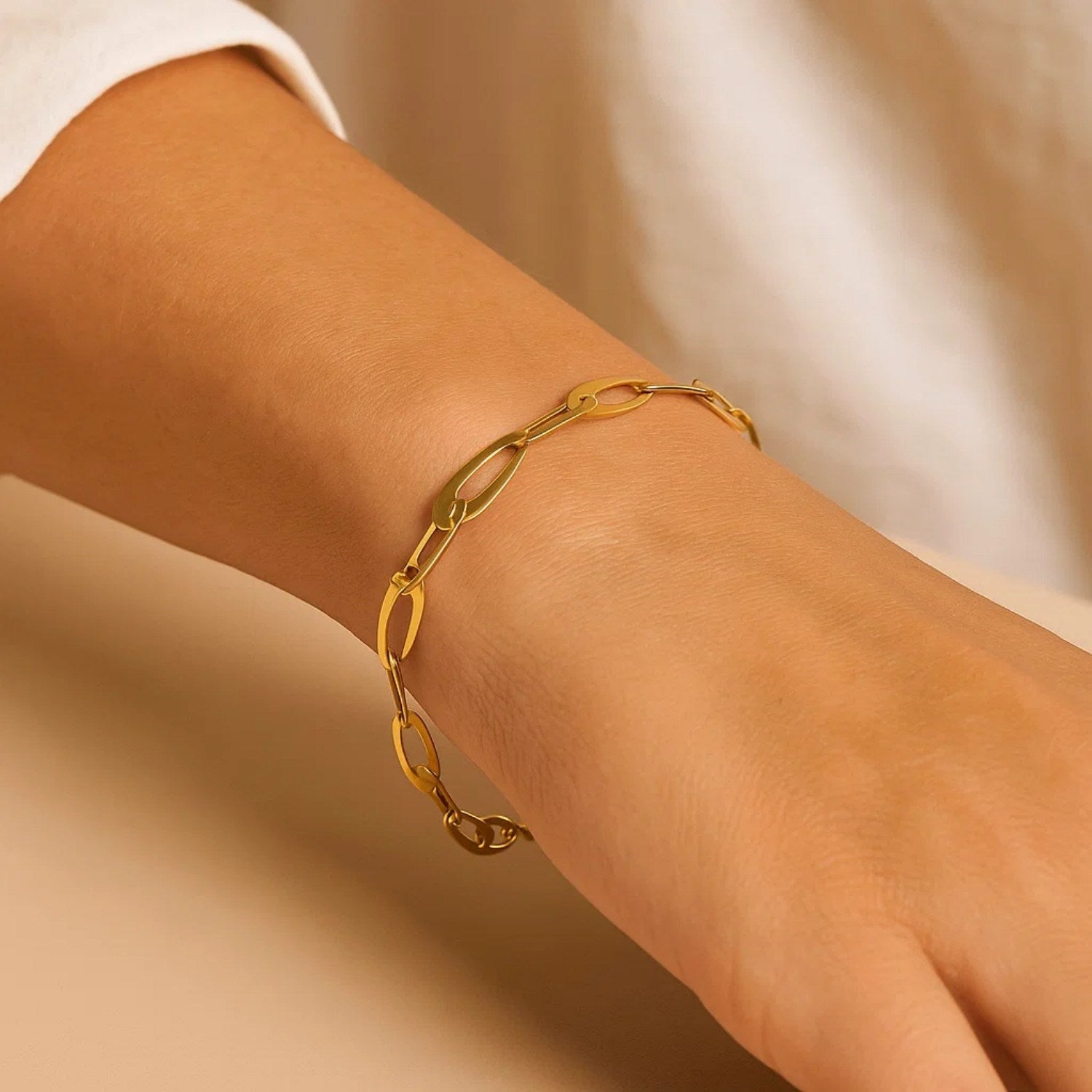 14k yellow gold Italian oval links bracelet on a person's wrist.
