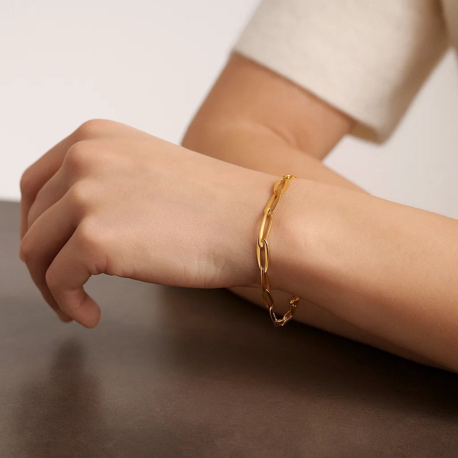 14k yellow gold Italian oval links bracelet on a person's wrist.
