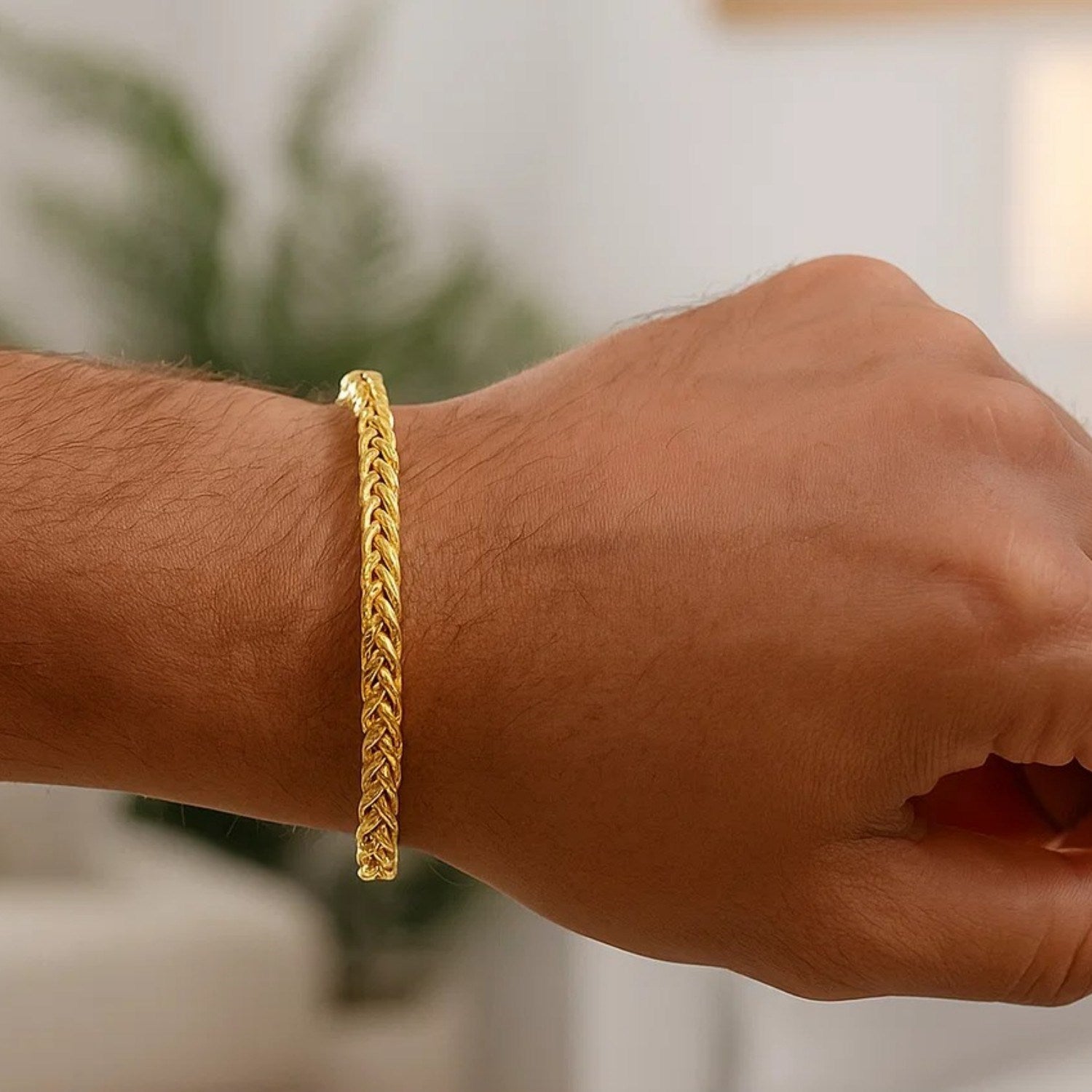 14k yellow gold diamond cut round franco bracelet on a person's wrist.