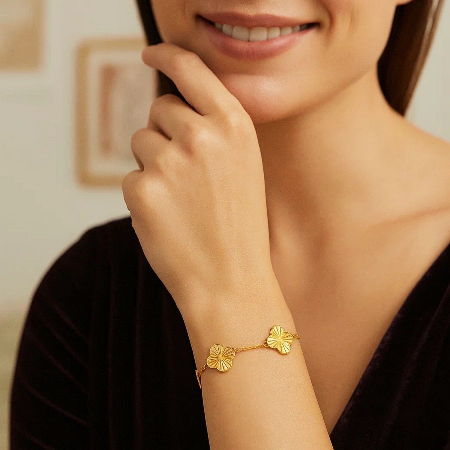 14K yellow gold clover bracelet on a woman's wrist.