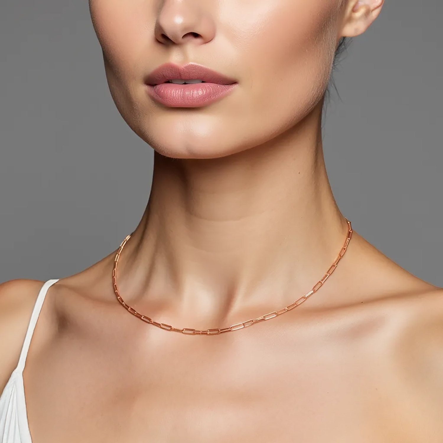 14K rose gold fine paperclip chain (1.50 mm) on a model's neck.