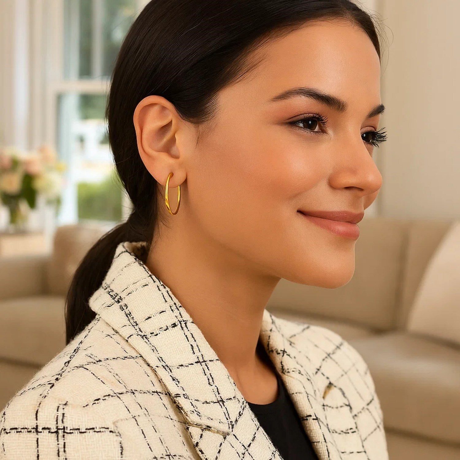 10k yellow gold polished hoop earrings on a woman.