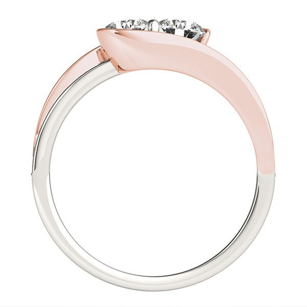 Two-tone white and rose gold ring with two prominent round diamonds and side diamonds.