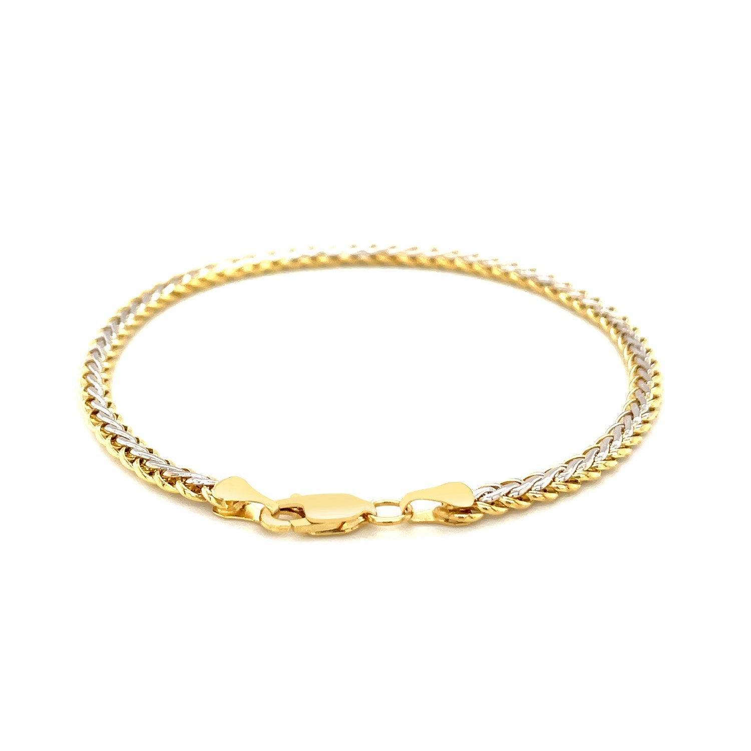 Two-toned wheat chain bracelet in 10k yellow and white gold with a lobster clasp.