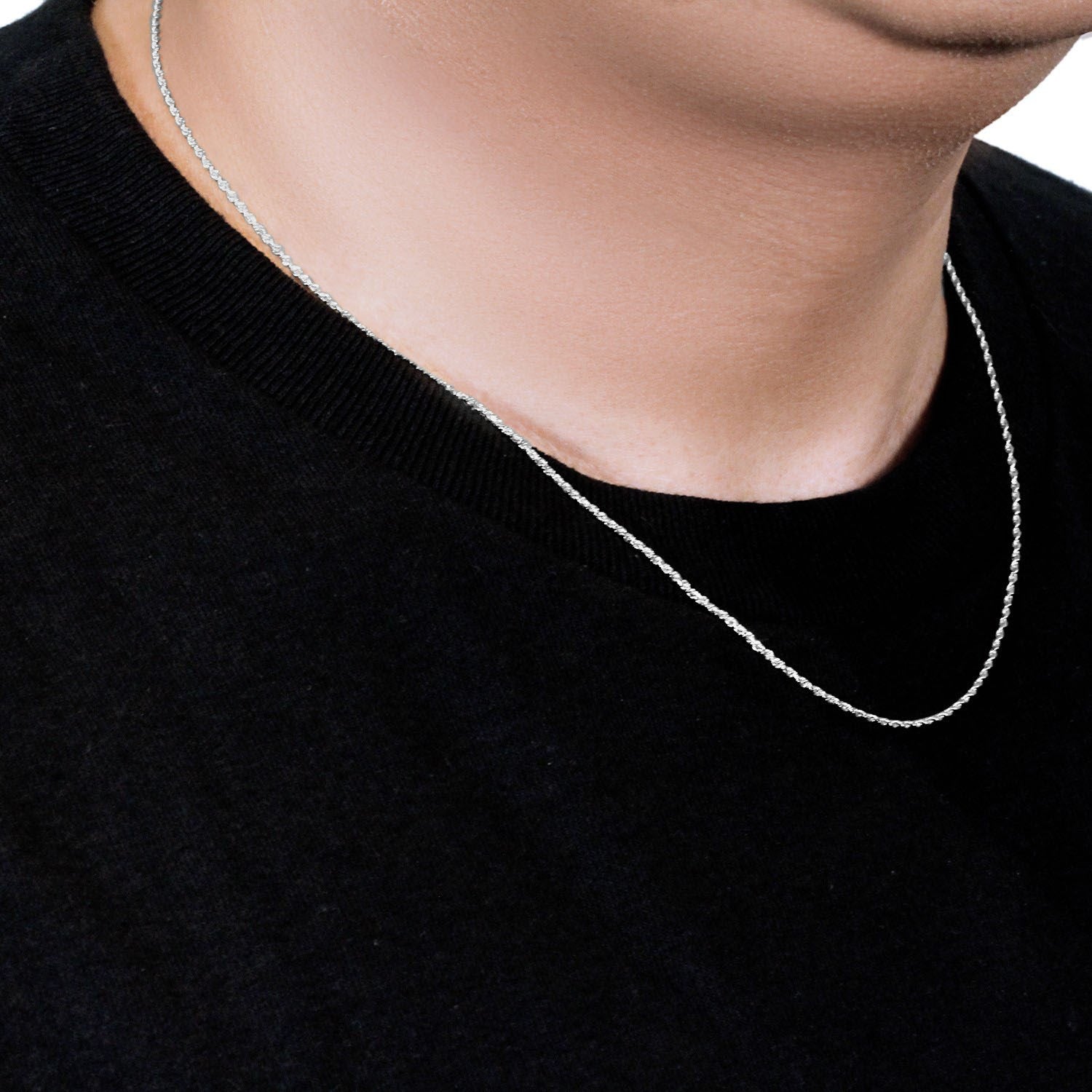A 10k white gold solid diamond cut rope chain on a person's neck.