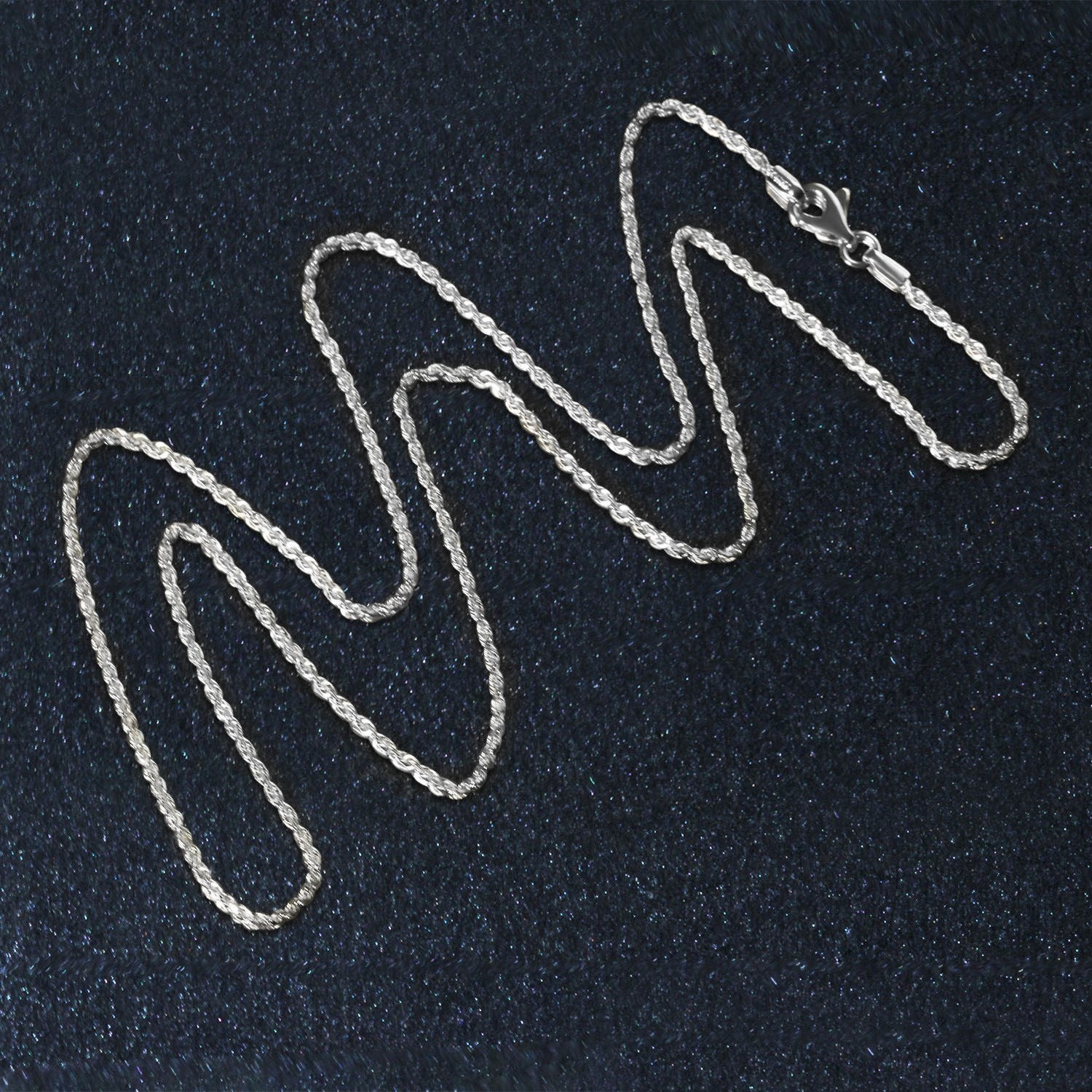 A 10k white gold solid diamond cut rope chain with a lobster clasp.