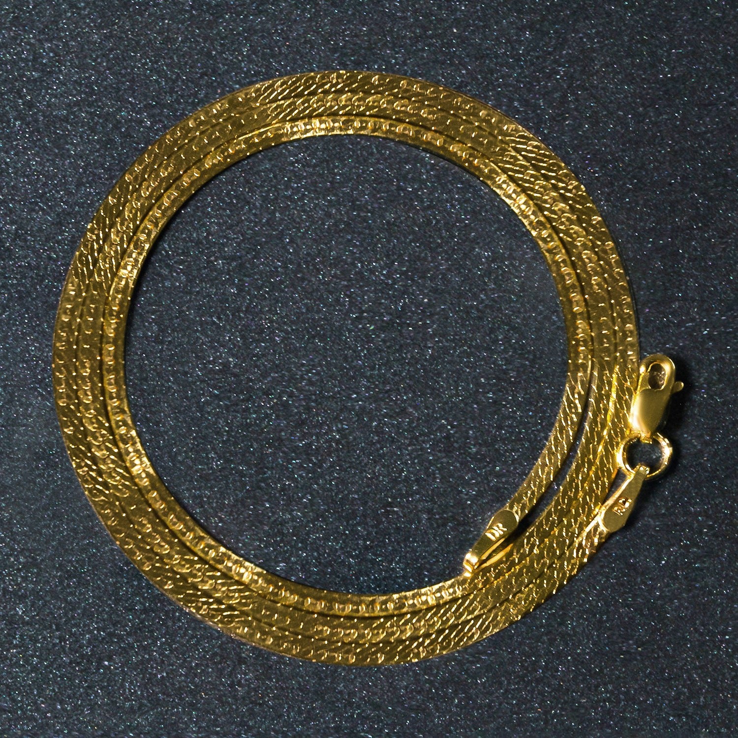14k yellow gold super flex herringbone chain with a lobster clasp.