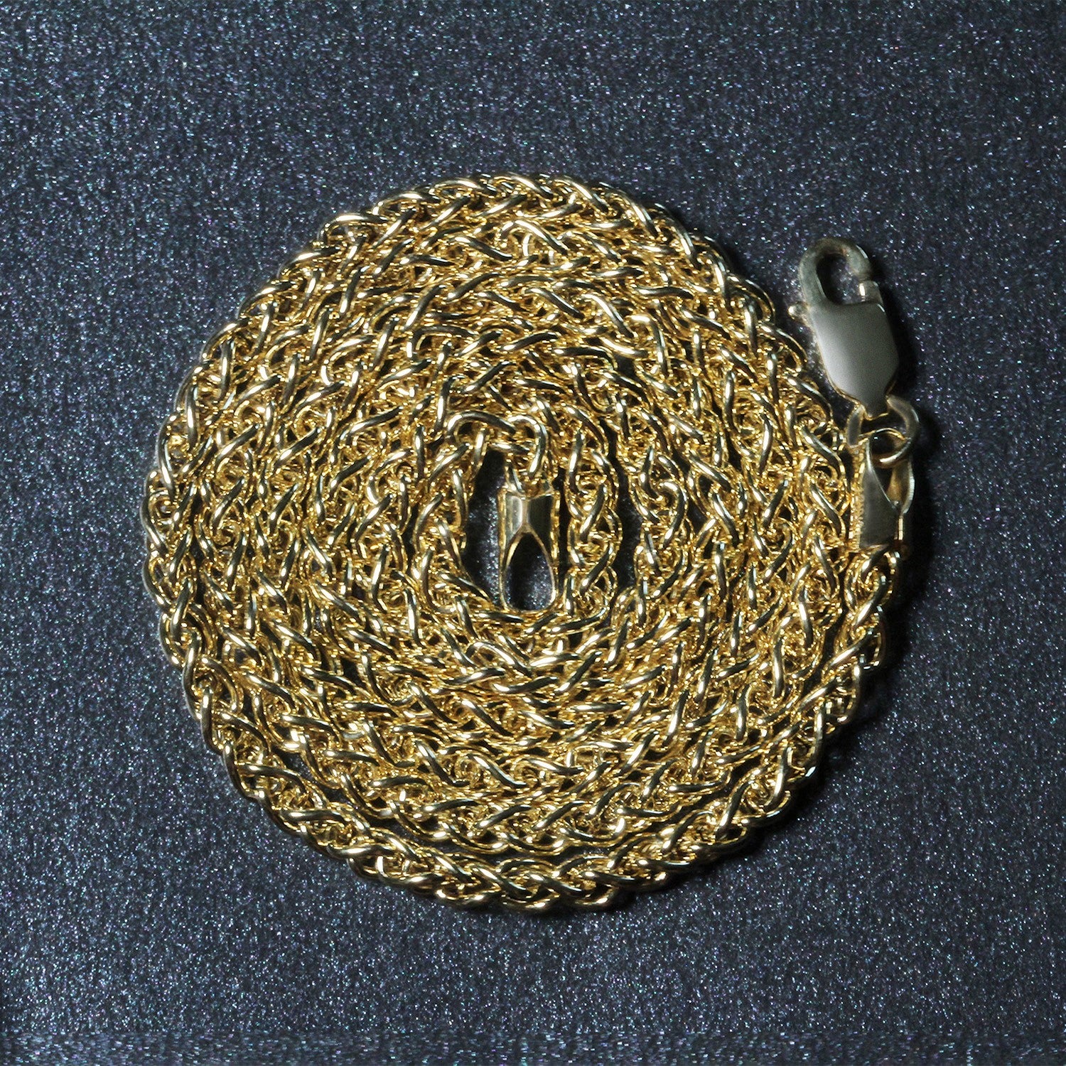 14k yellow gold light weight wheat chain with a lobster clasp.